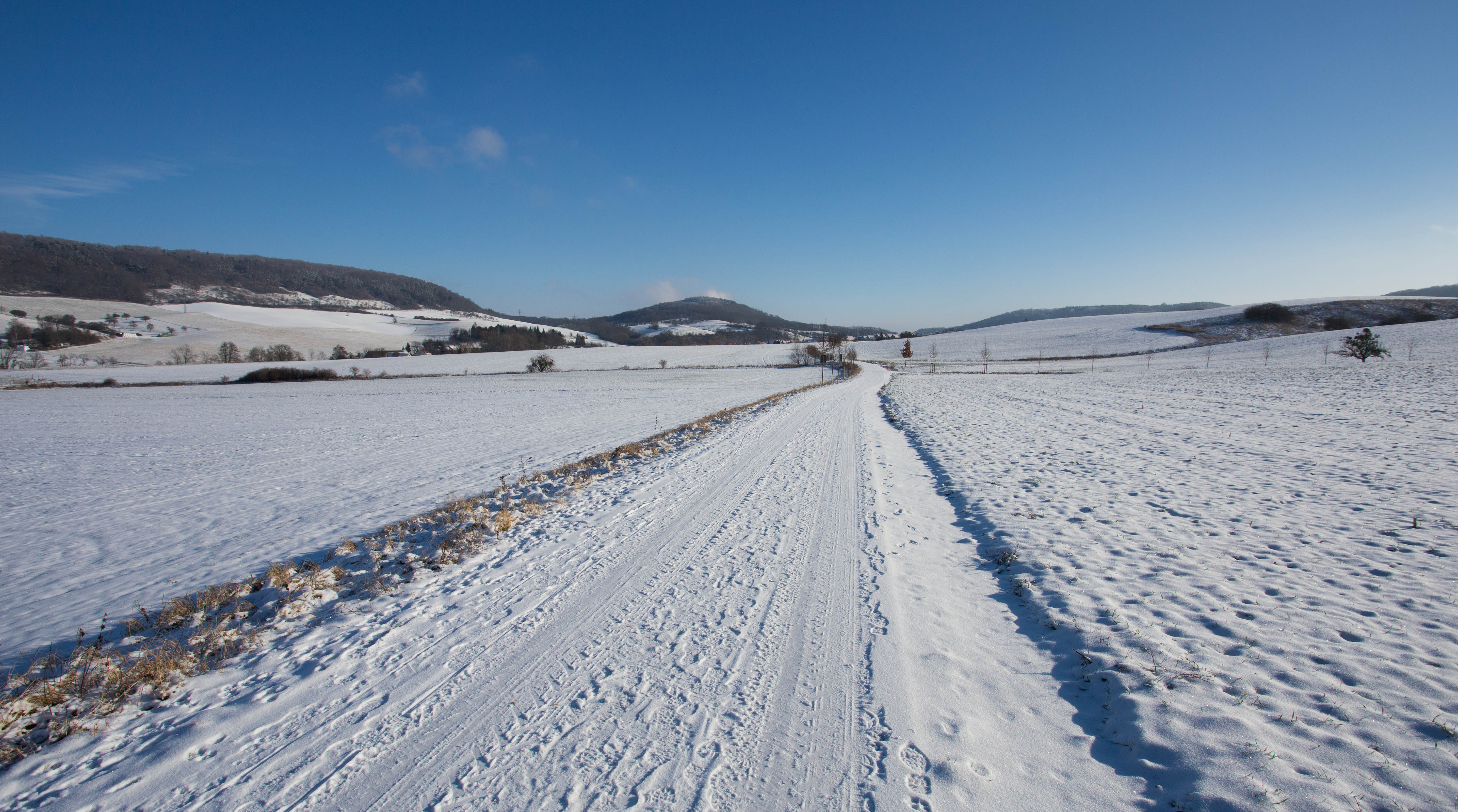 Carefully traversing snow-covered tracks east of Jena, Germany