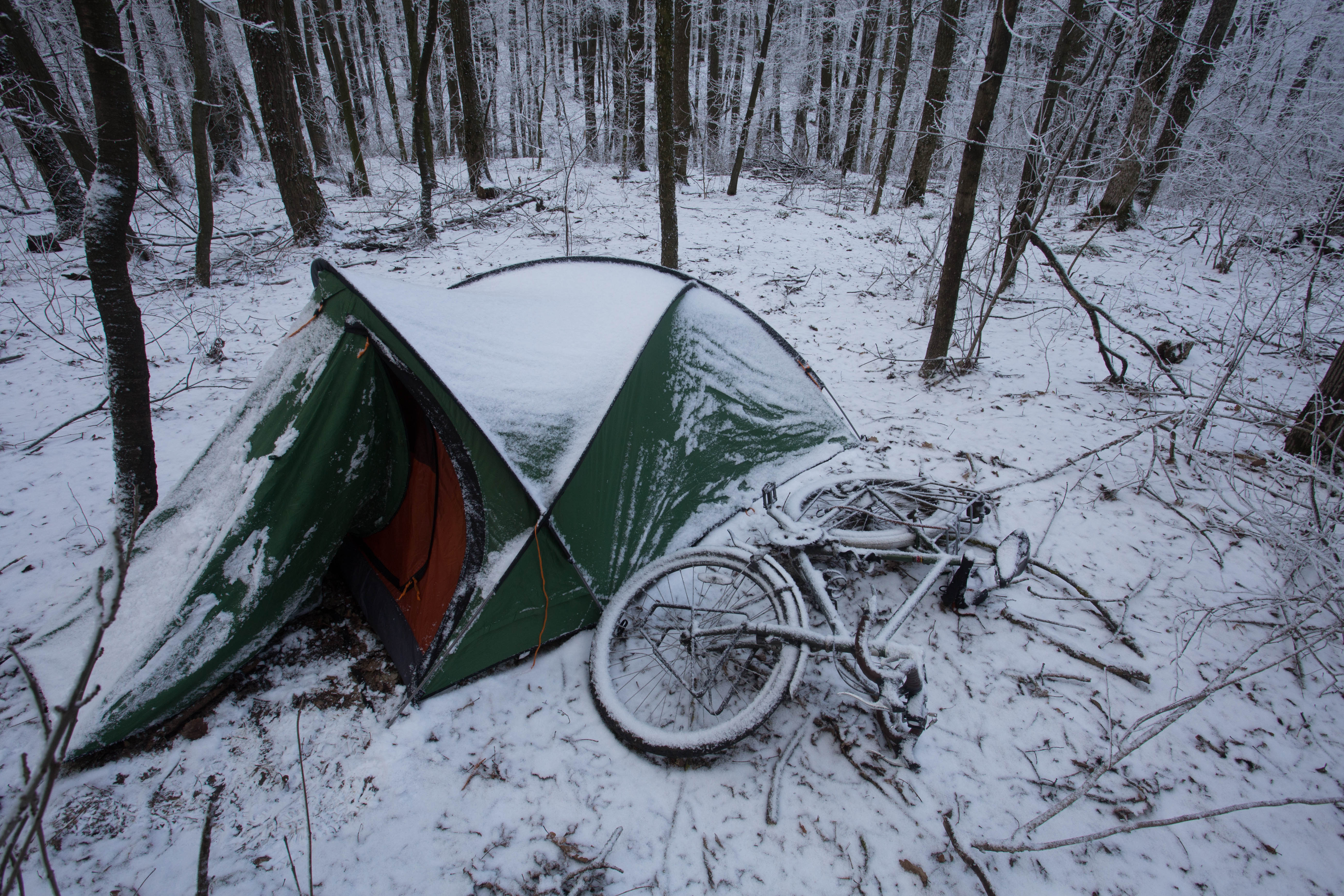 Waking up to the incredible sight of my tent and bicycle draped in snow in rural Moldova