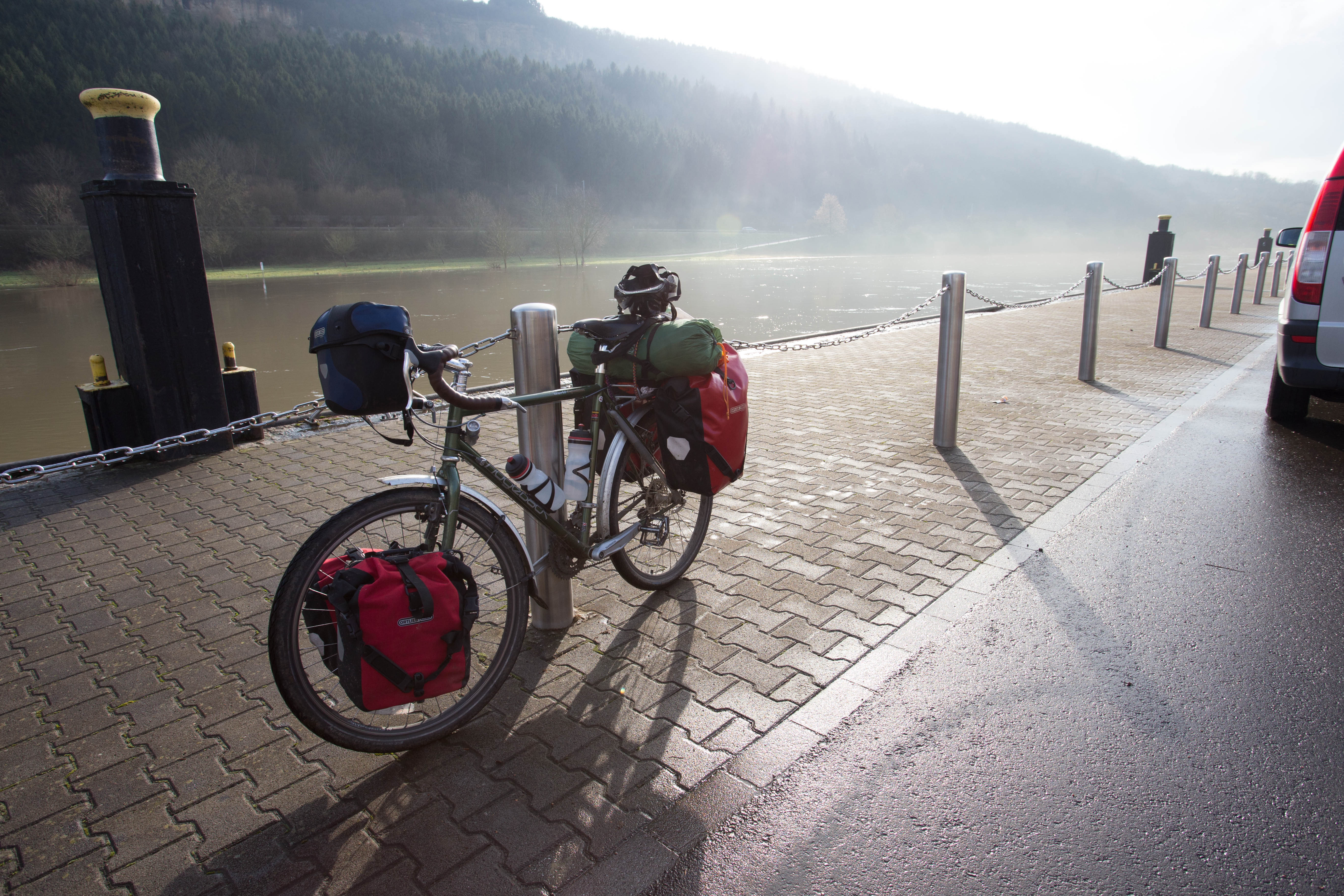 The morning mist simmering on the water's surface as I pedal the final kilometres of Luxembourg