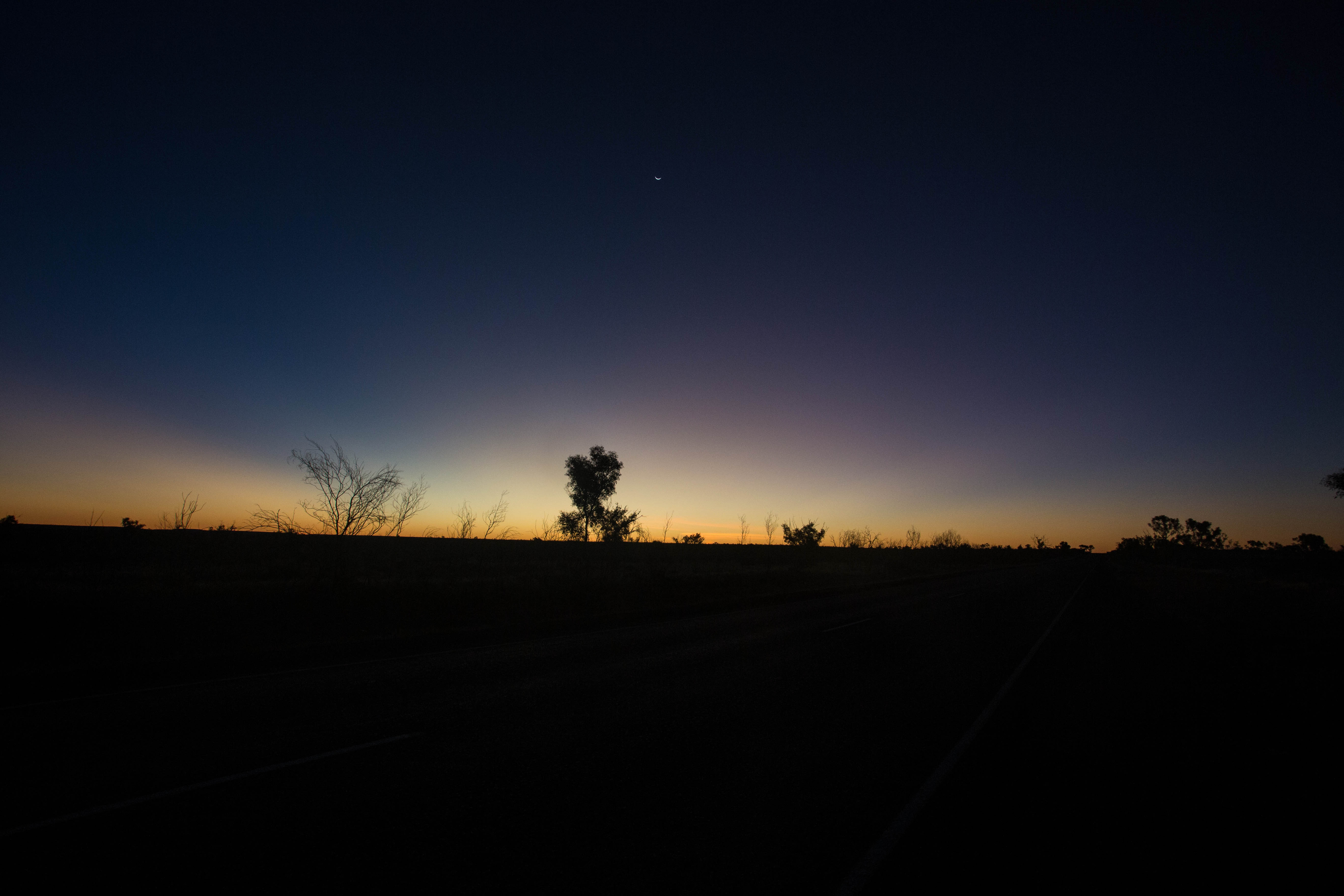 The sun dropping beneath the horizon in the remote Outback as I pedal onwards into the night