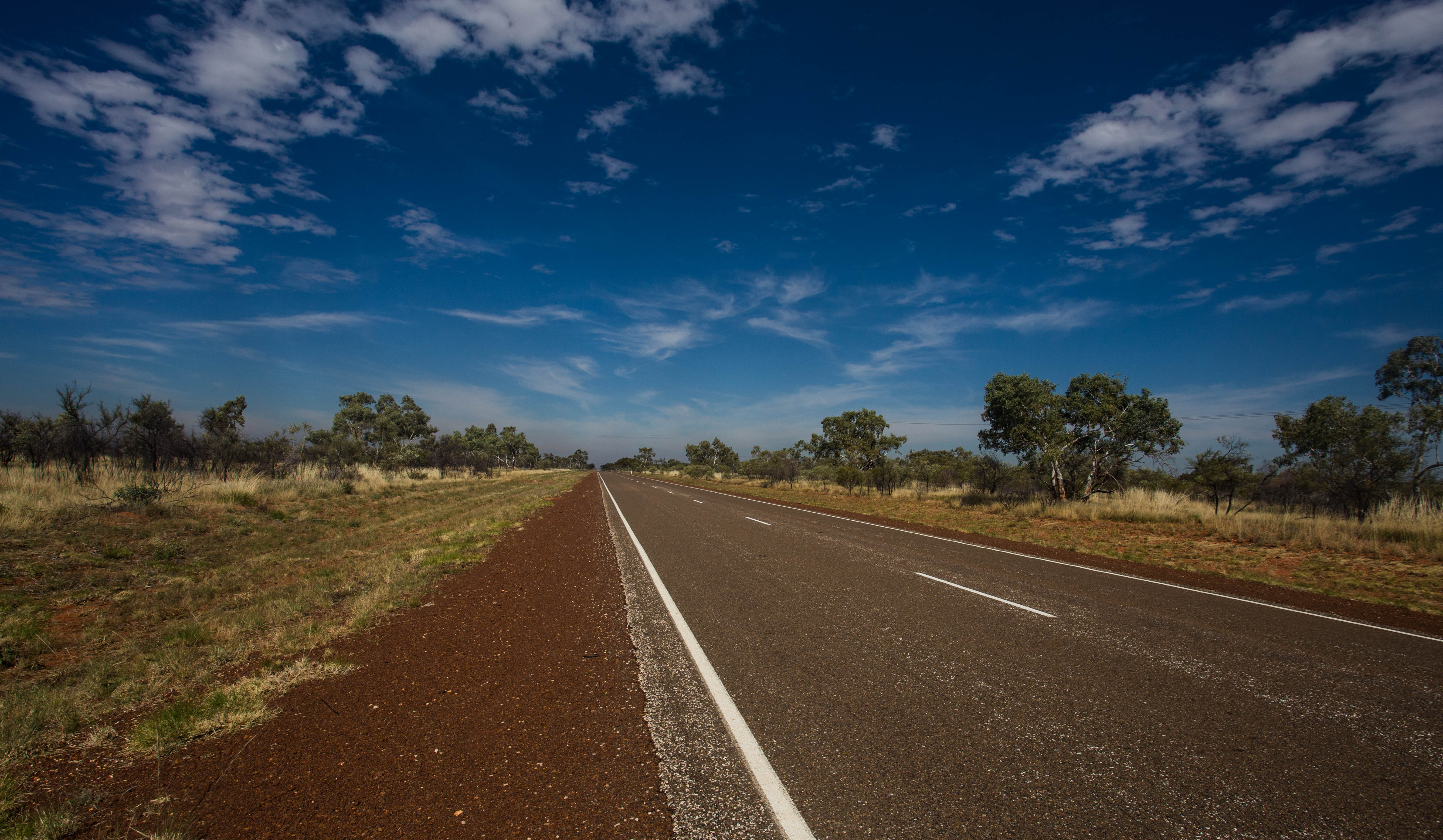 Sprinting across the dusty plains south of Tennant Creek as a tailwind finally materialises and helps me push out a 186-kilometre day