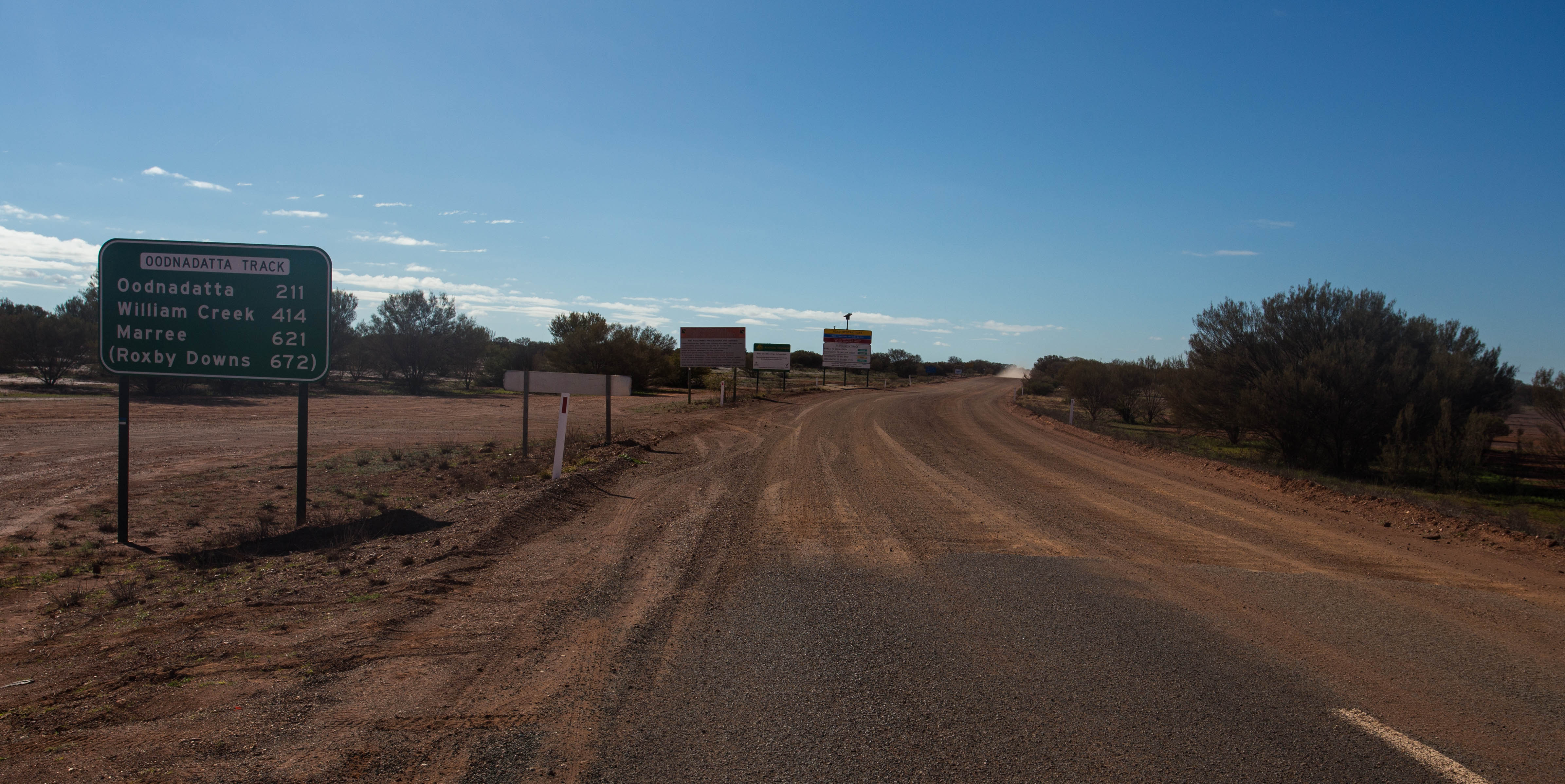 Being greeted by a sign with some rather scary distances between water/food sources as I turn onto the dirt of the Oodnadatta Track