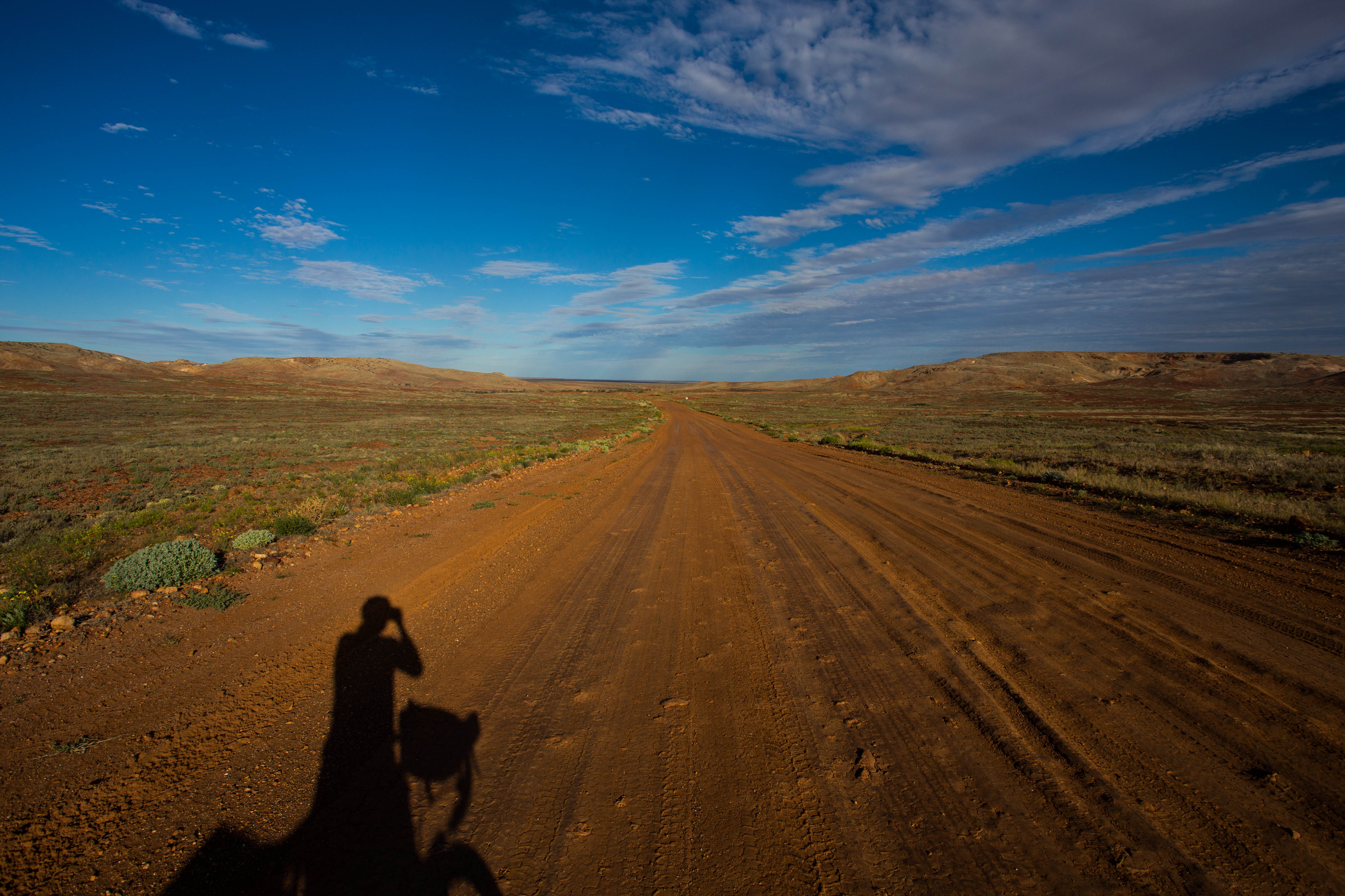 Chasing my shadow eastwards, further into the wilderness as the sun begins to set over the Outback