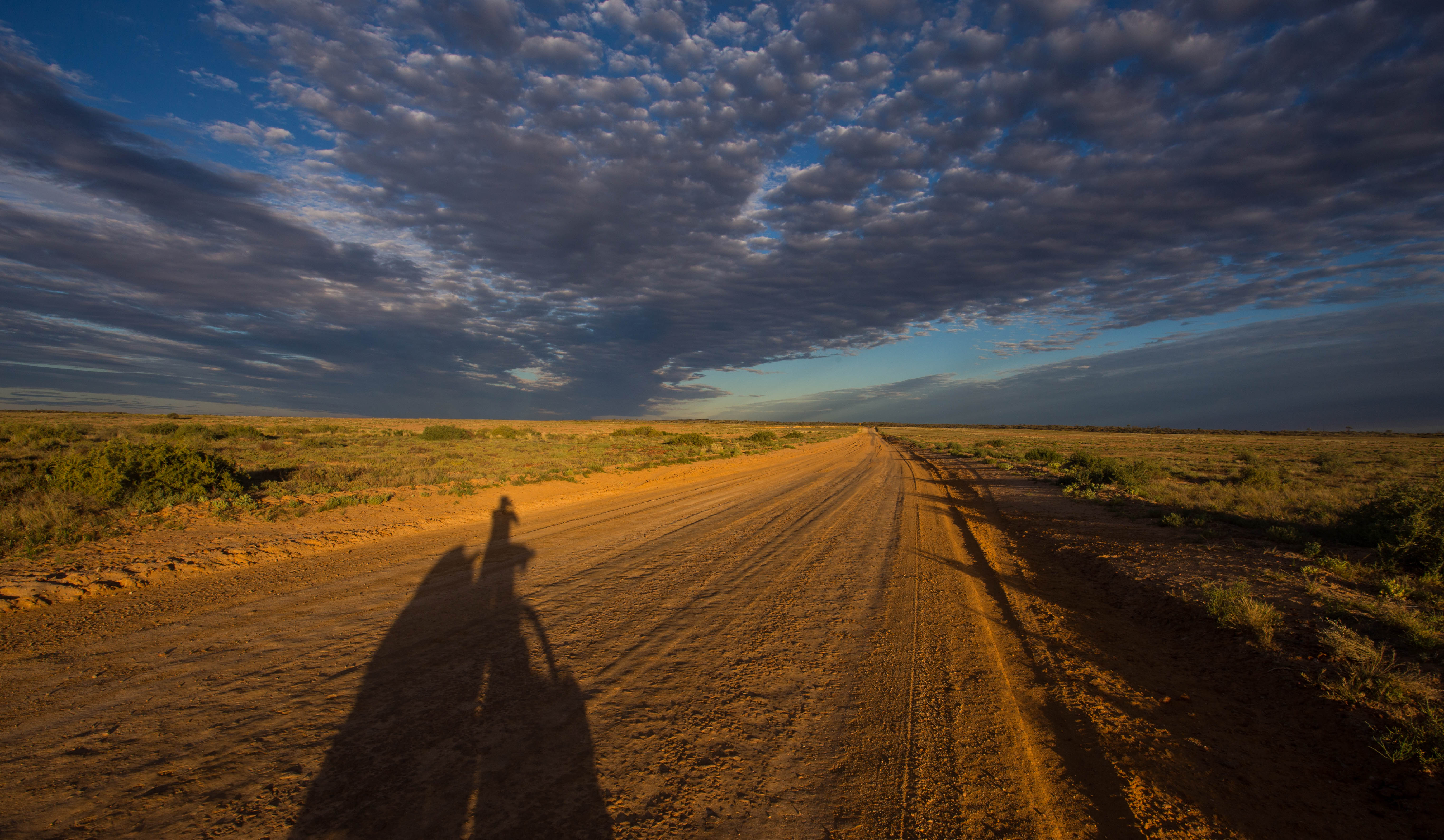 Chasing my shadow eastwards, further into the wilderness as the sun begins to set over the Outback