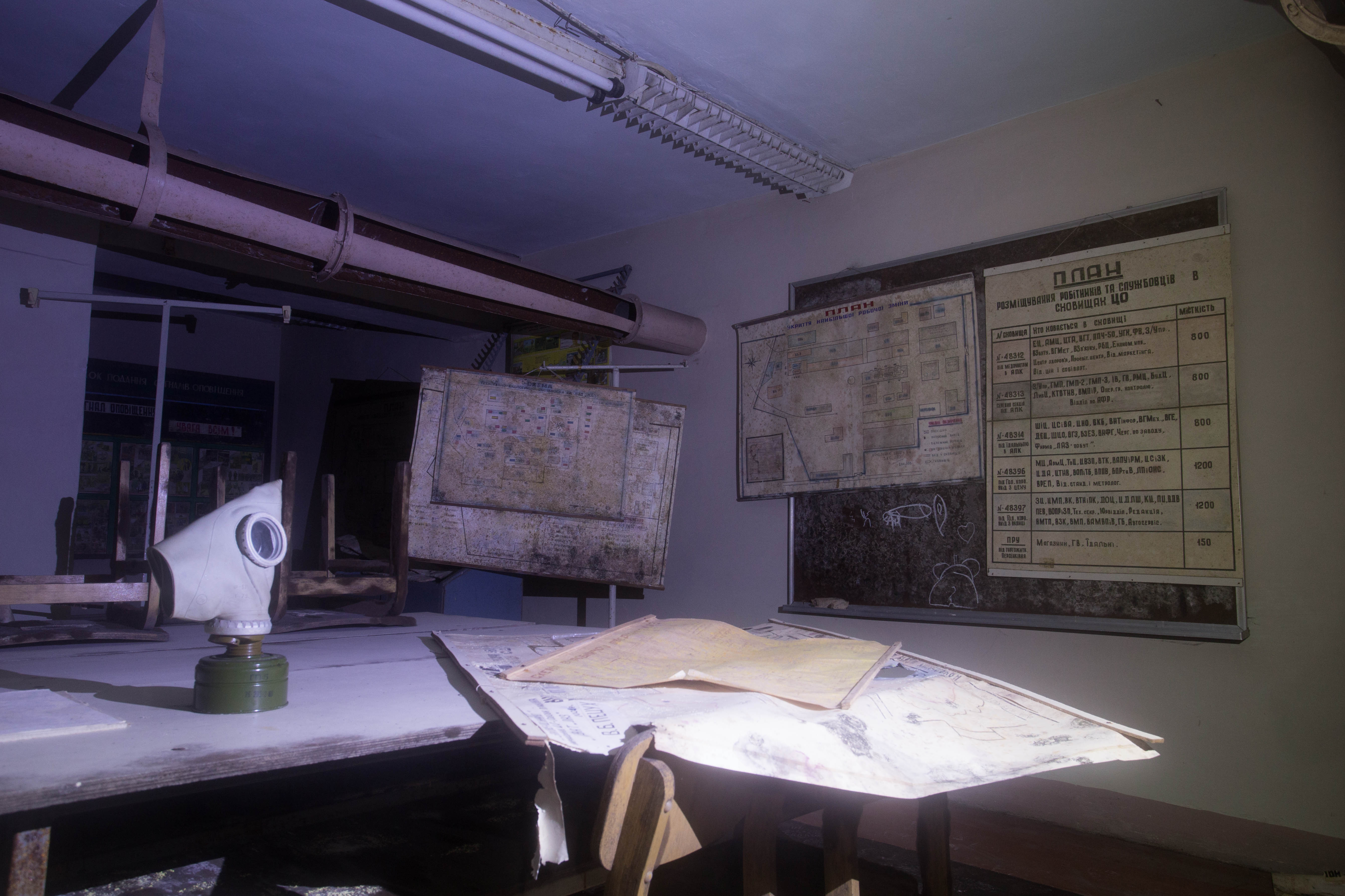 An old gas mask sitting in the main classroom of the nuclear bunker