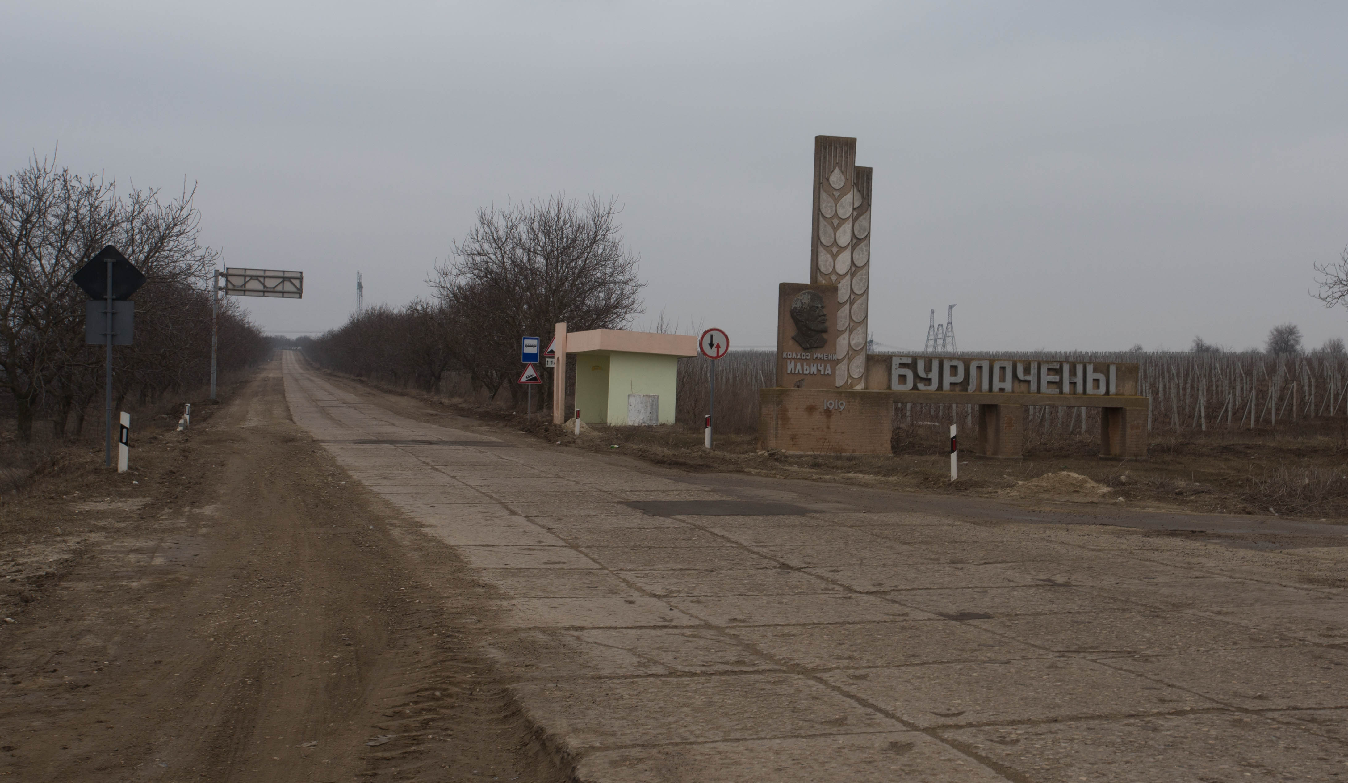 The bleakness of southern Moldova in winter: grey skies, battered roads, brown torn up earth and monuments to Lenin