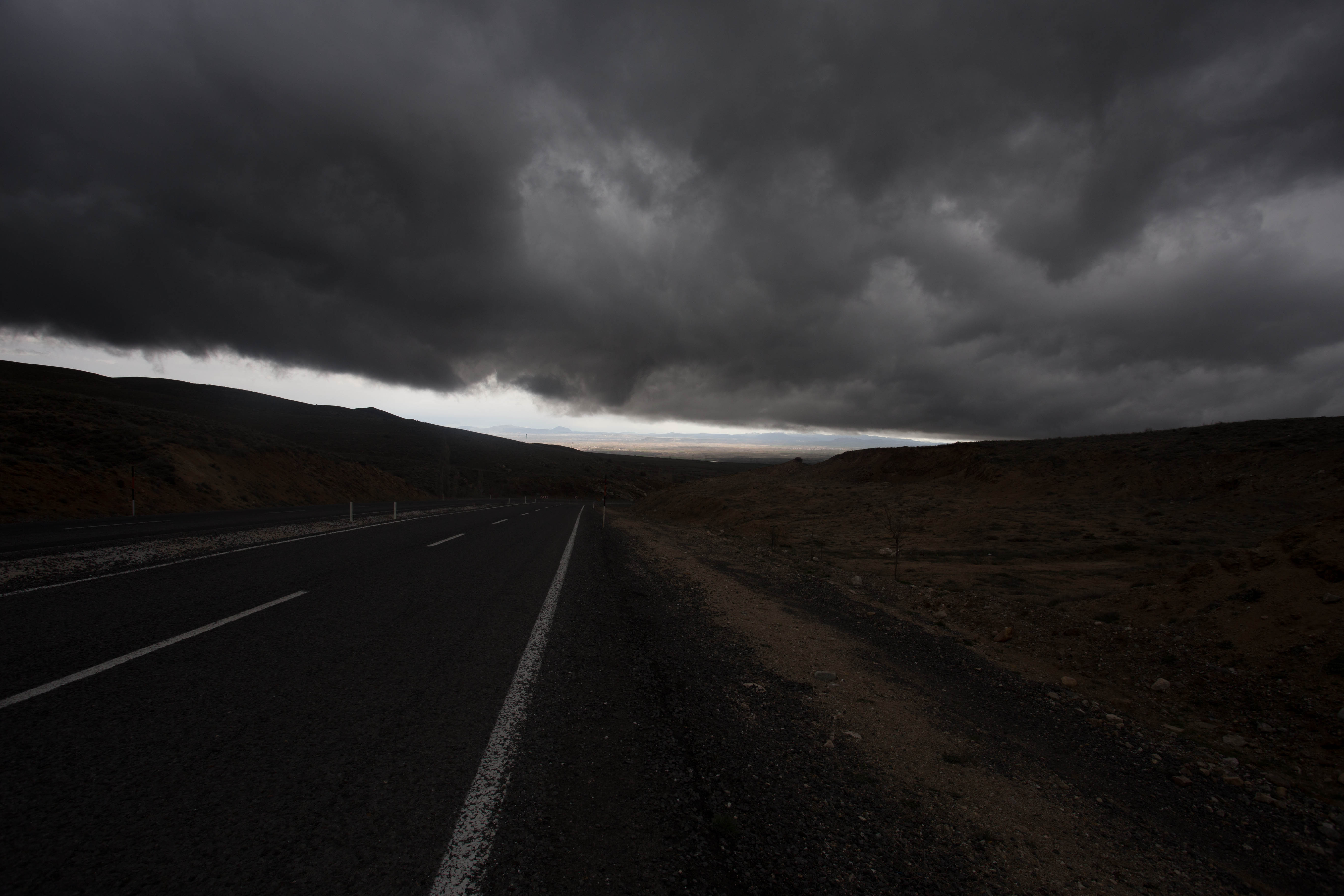 Racing down the descent at 70km/h, aiming to break through the storm threatening to swallow me up before I reached the sunlit plains of Cappadocia 