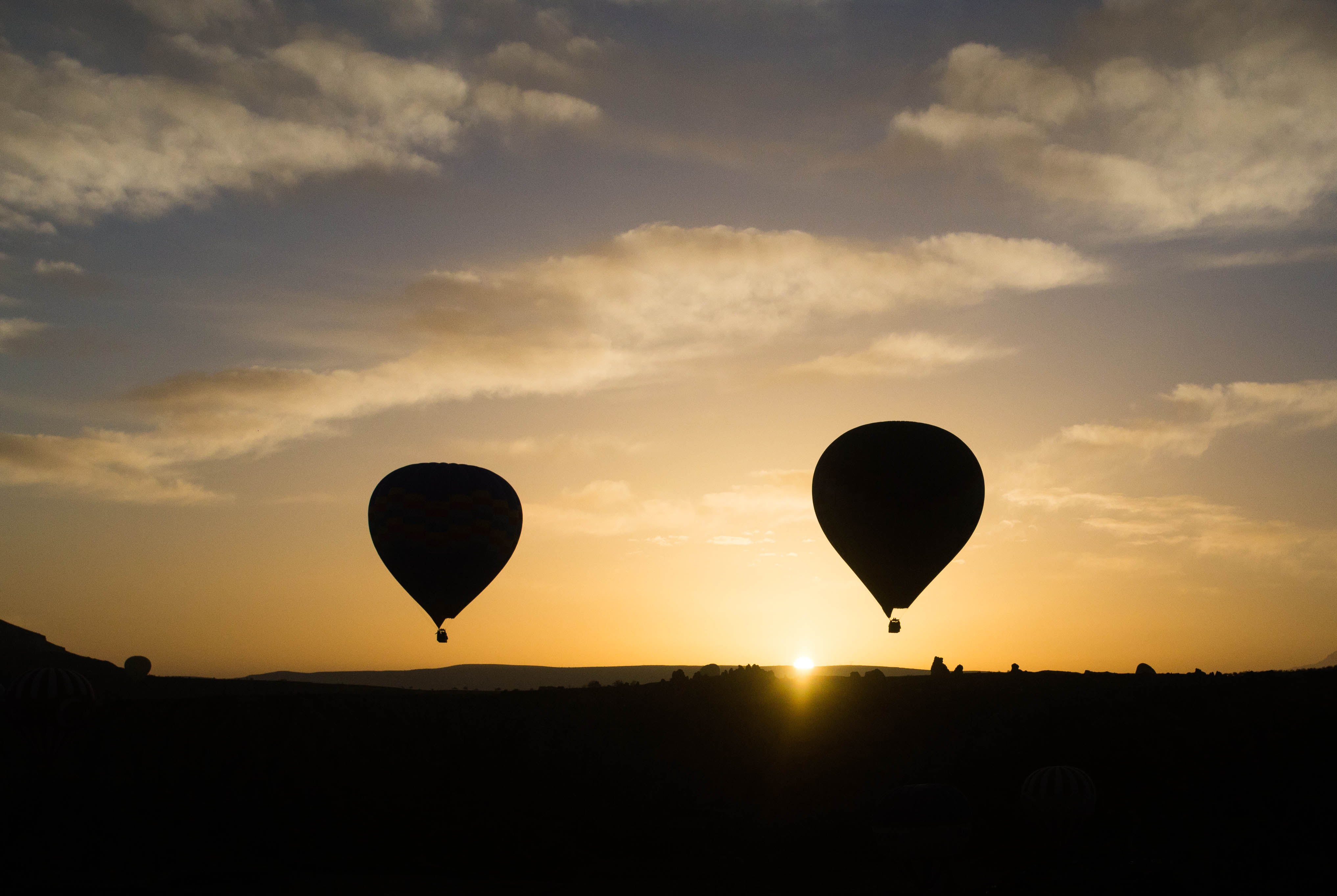 After a long, cold wait, we caught our first glimpse of these silhouetted hot-air balloons rising above Göreme