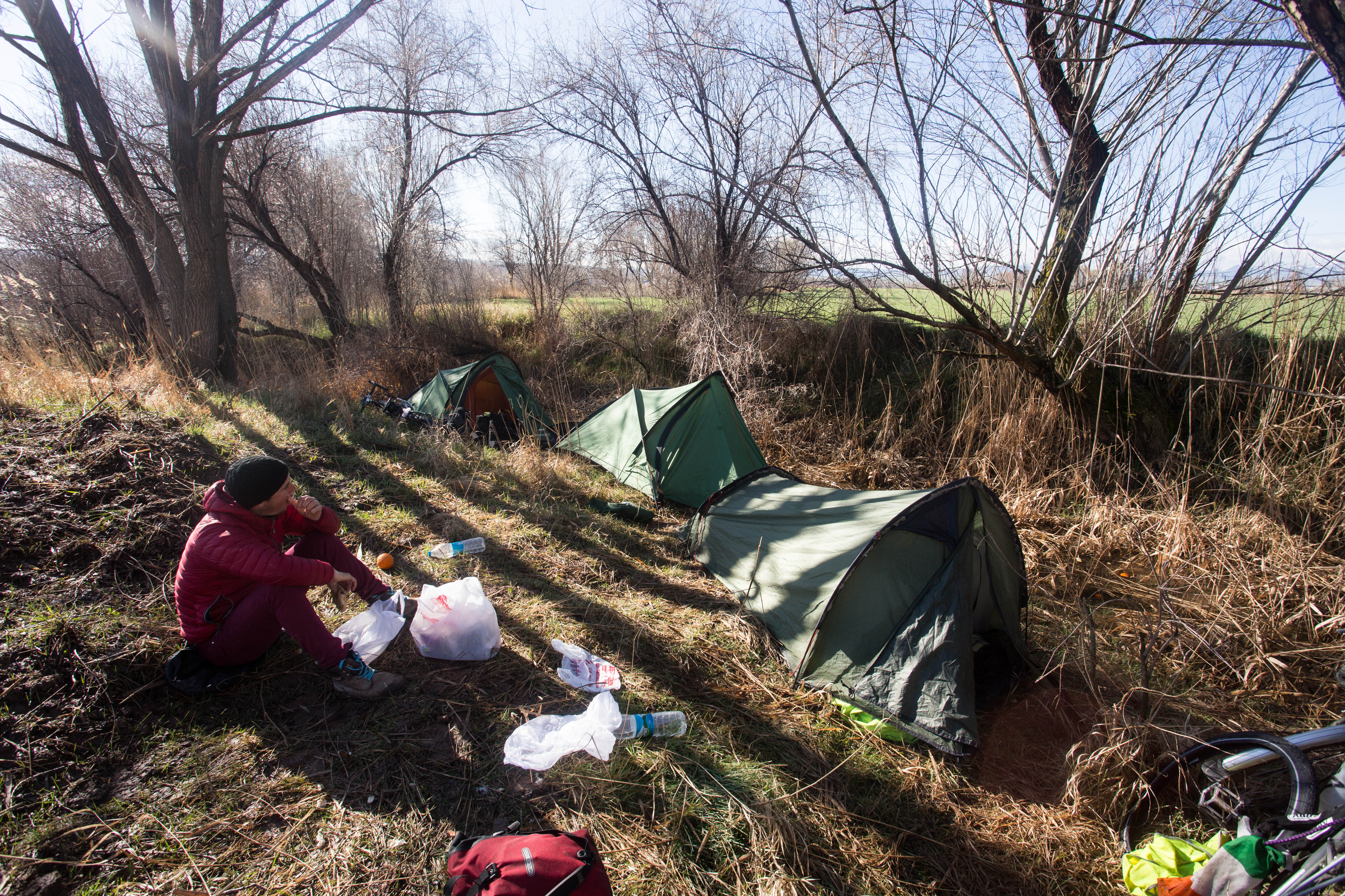 Digging into breakfast after a night spent wild camping, tucked away in a hidden corner of a field