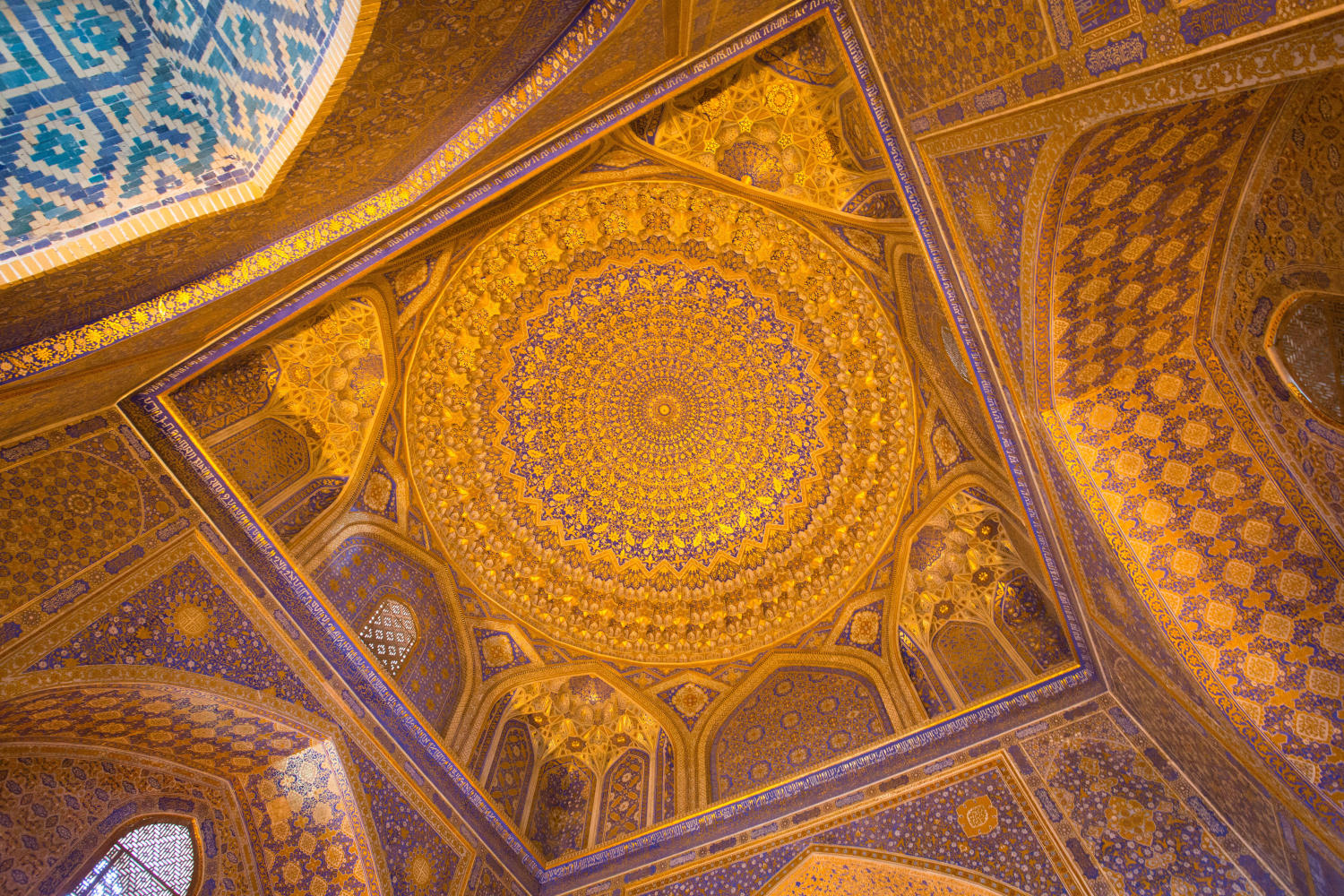 The ornate golden ceiling of one of Samarkand's many stunning madrassahs