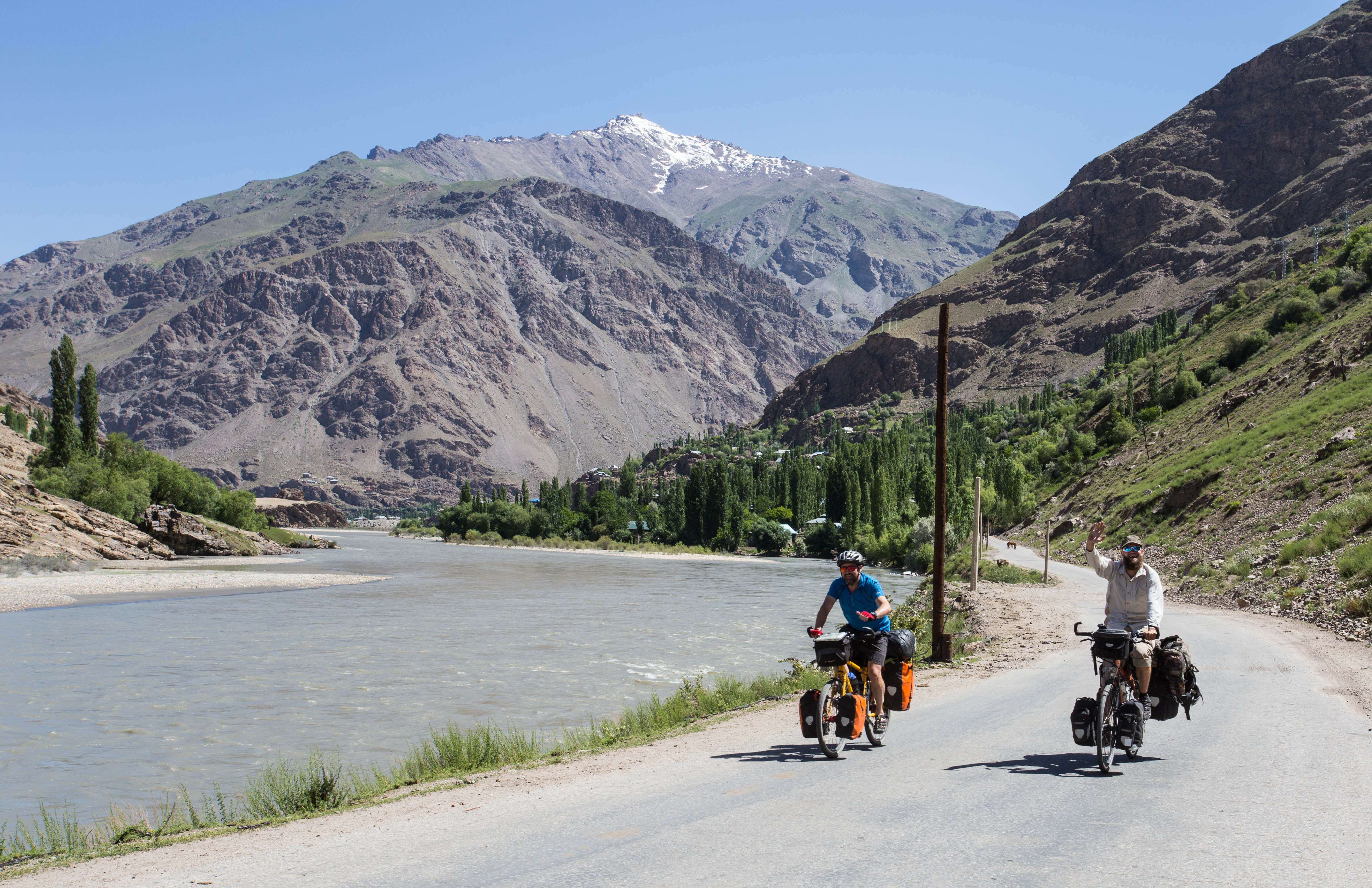 Mark and Tim cycling along the Panj as five of us set off into the Wakhan Valley