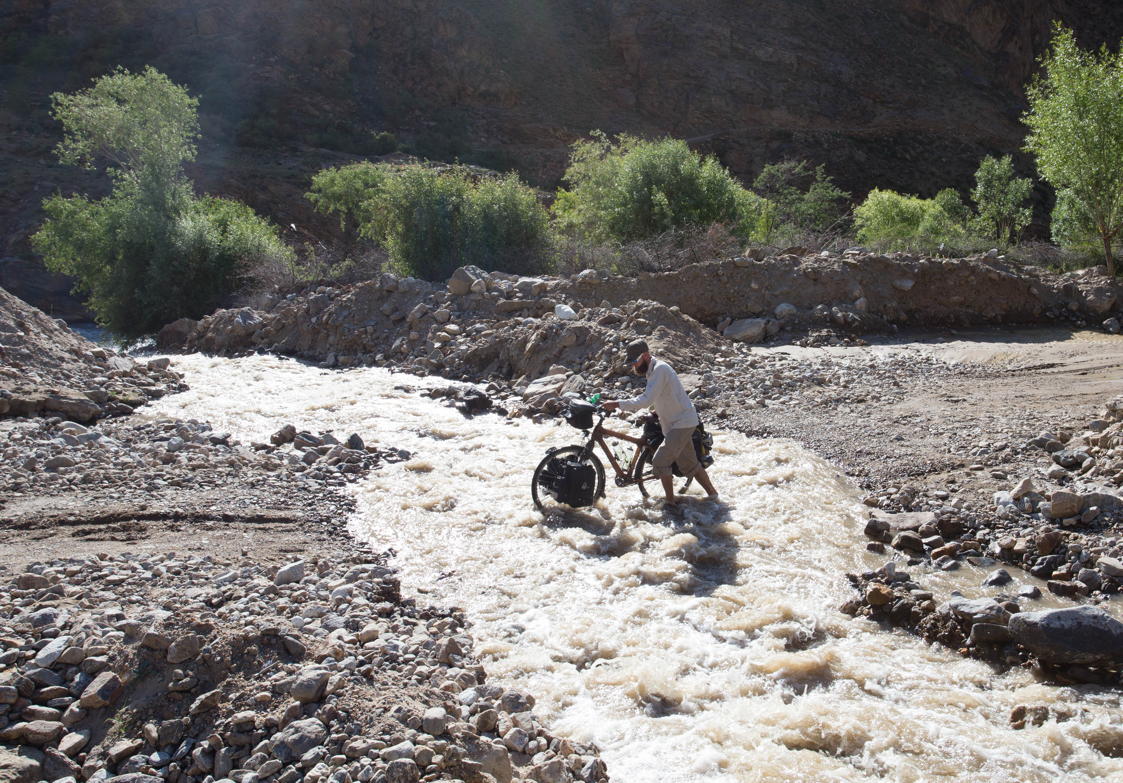 Tim pushing across one of the many little rivers which descend out of the mountains of the Wakhan Valley and into the Panj