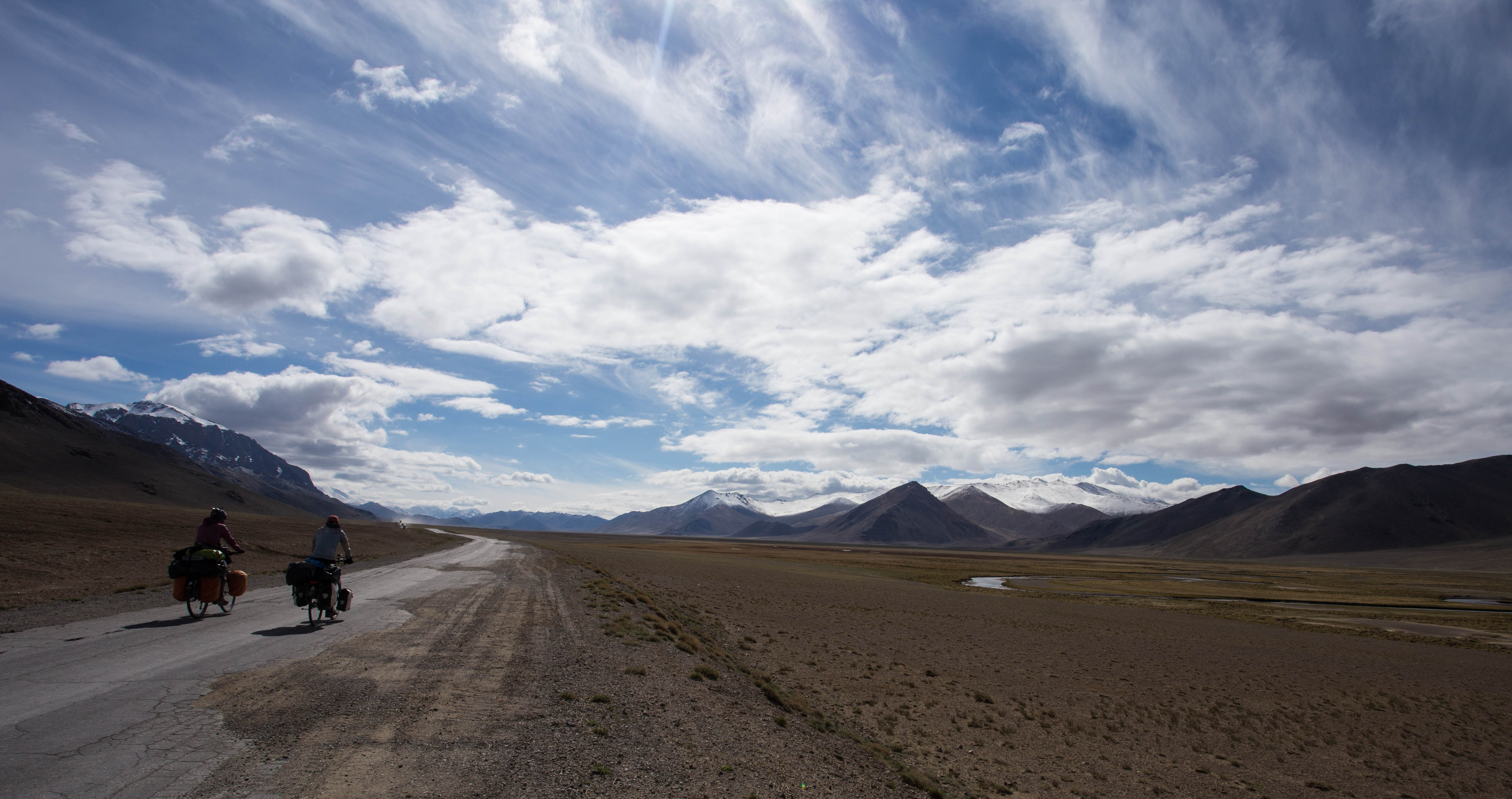 Kim and Matthew pedalling out onto the Pamir Plateau