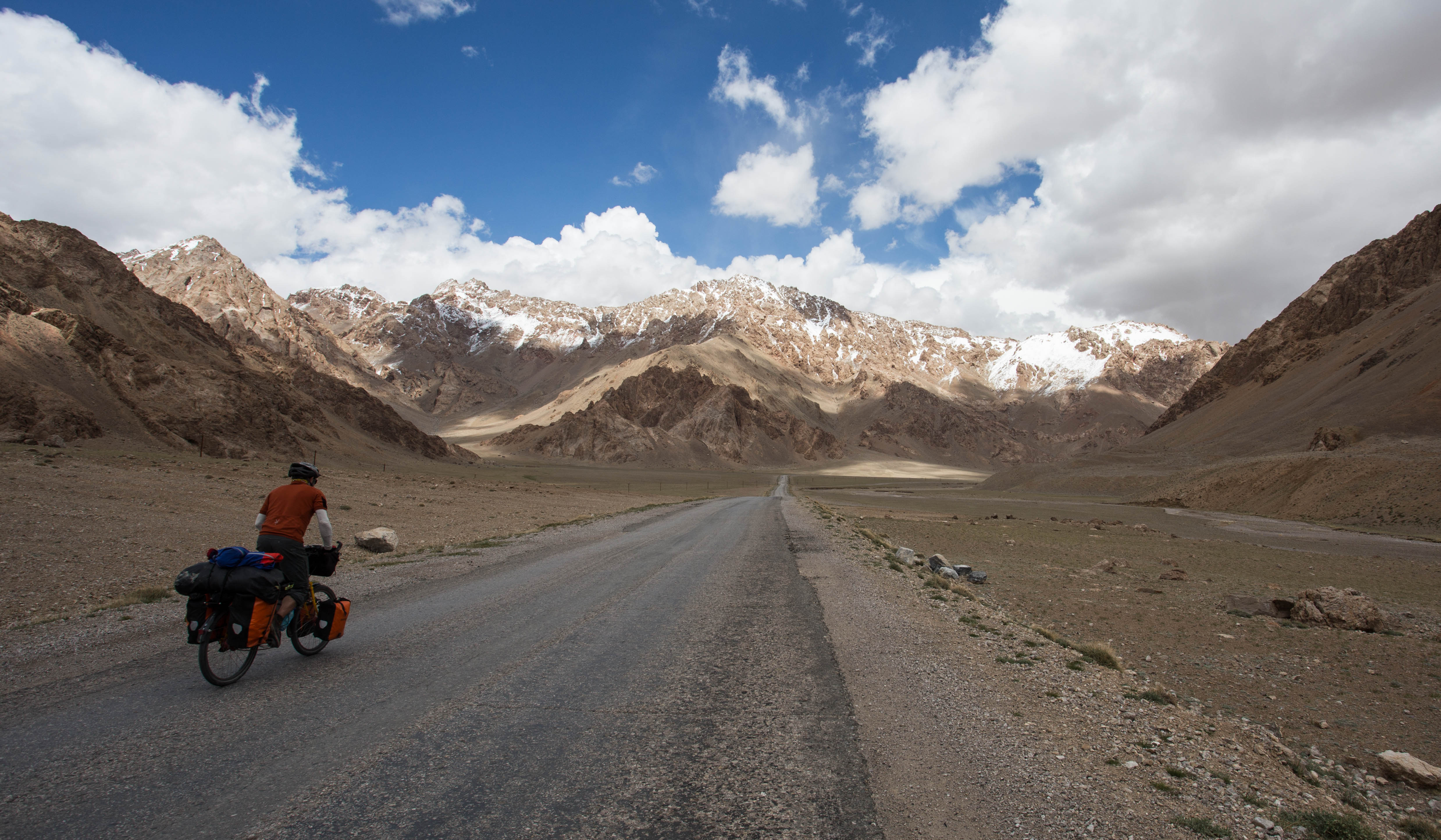 Mark tackling a brief climb on this mostly flat road through the Pamir Plateau