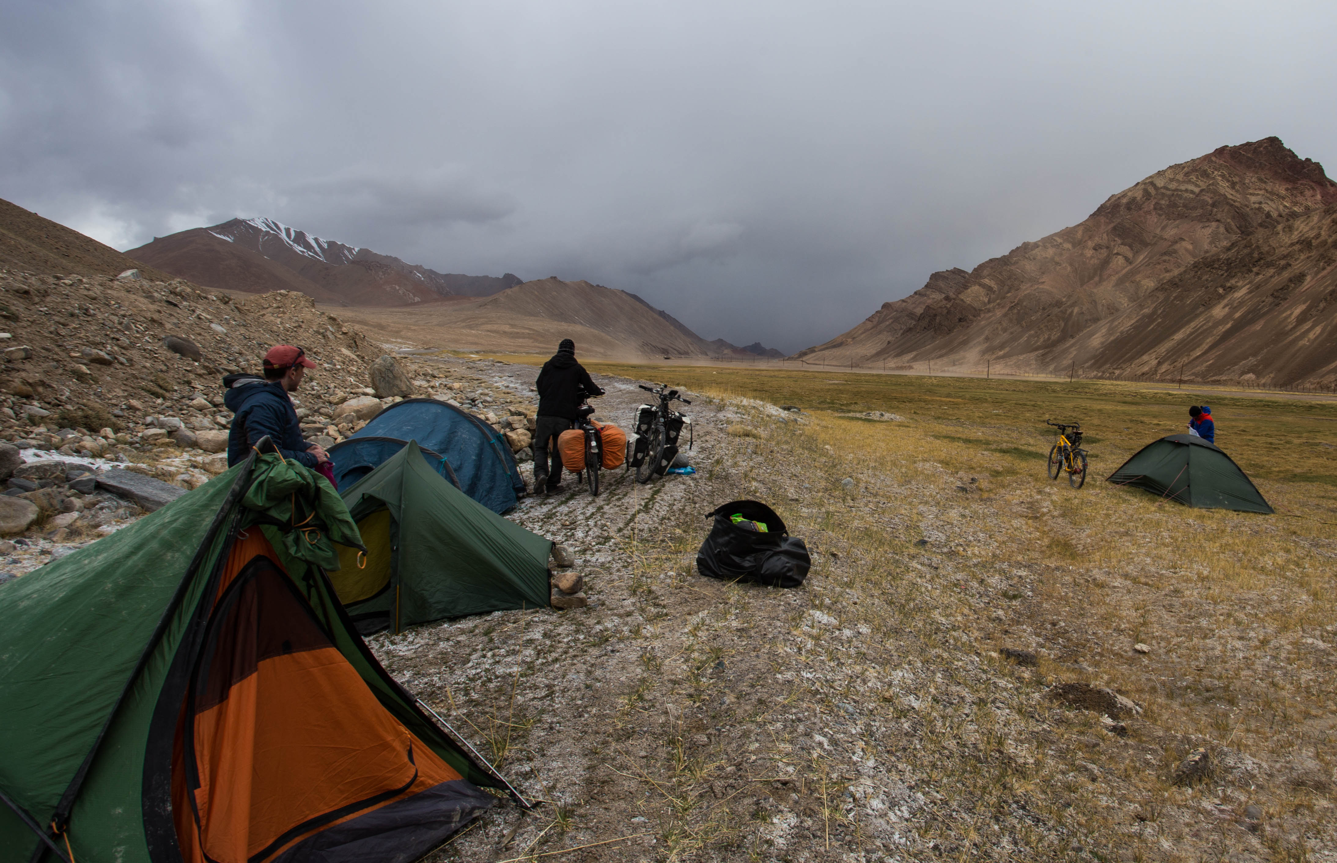 Rushing to pack our gear into our tents as a storm barrels down the valley towards us