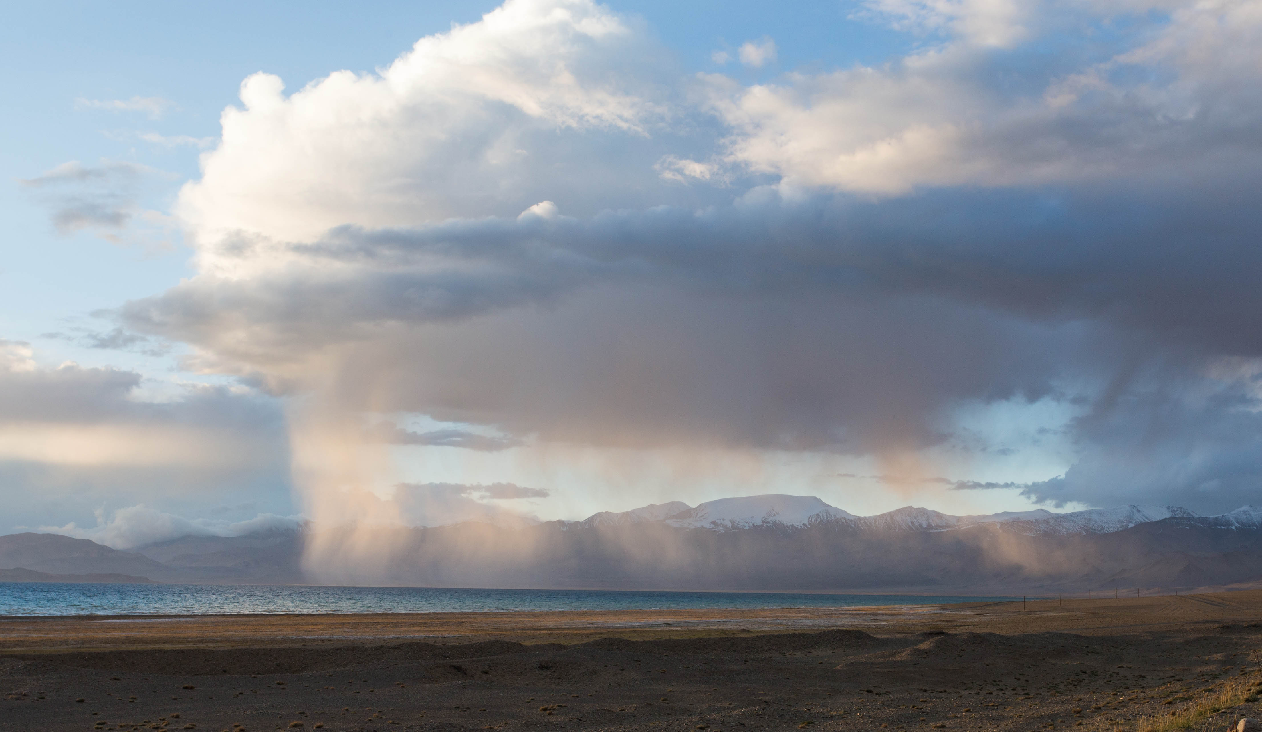 A heavy rain shower passing over the lake