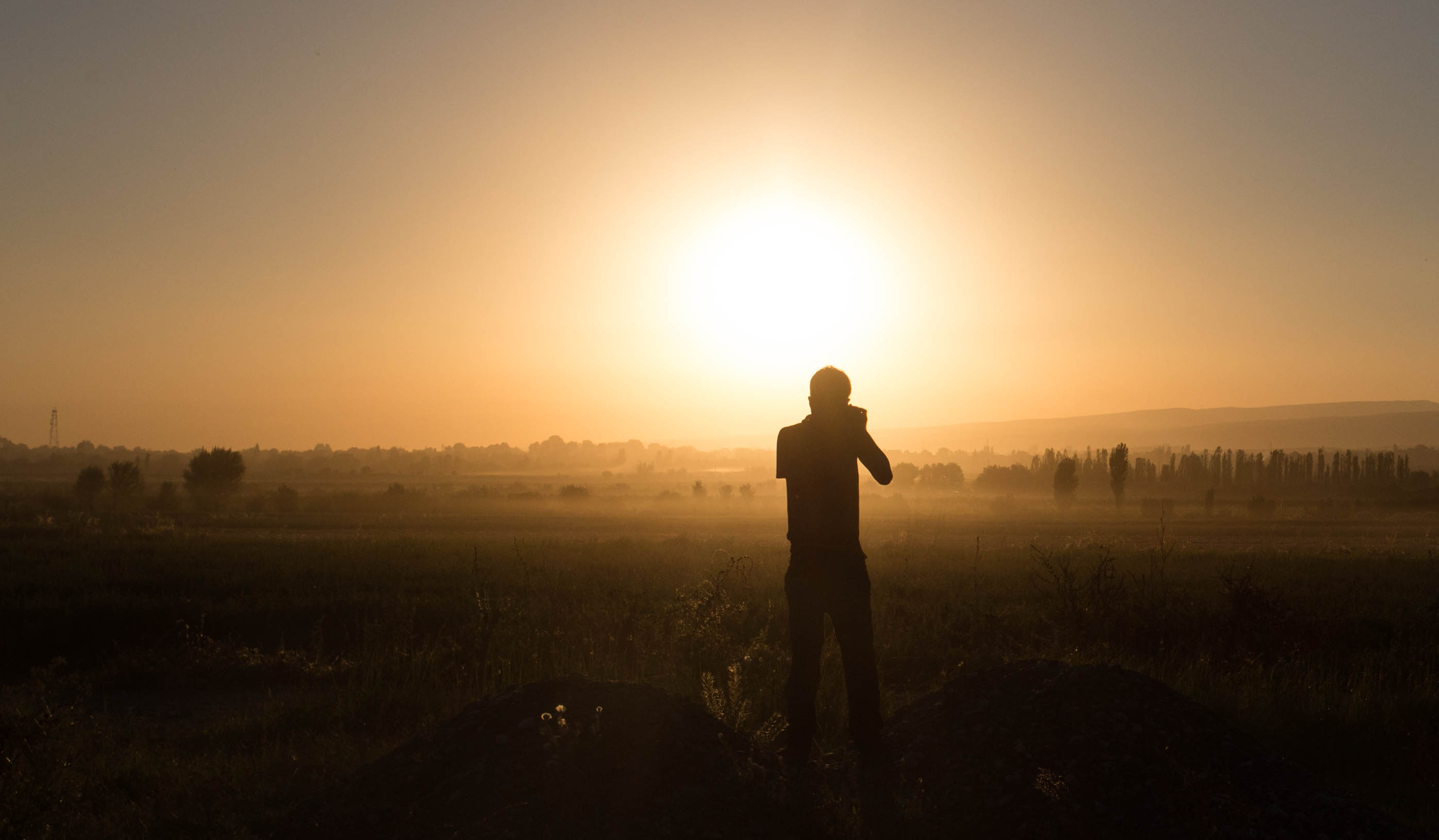 Kim photographing a beautiful sunset over the plains of the Fergana Valley