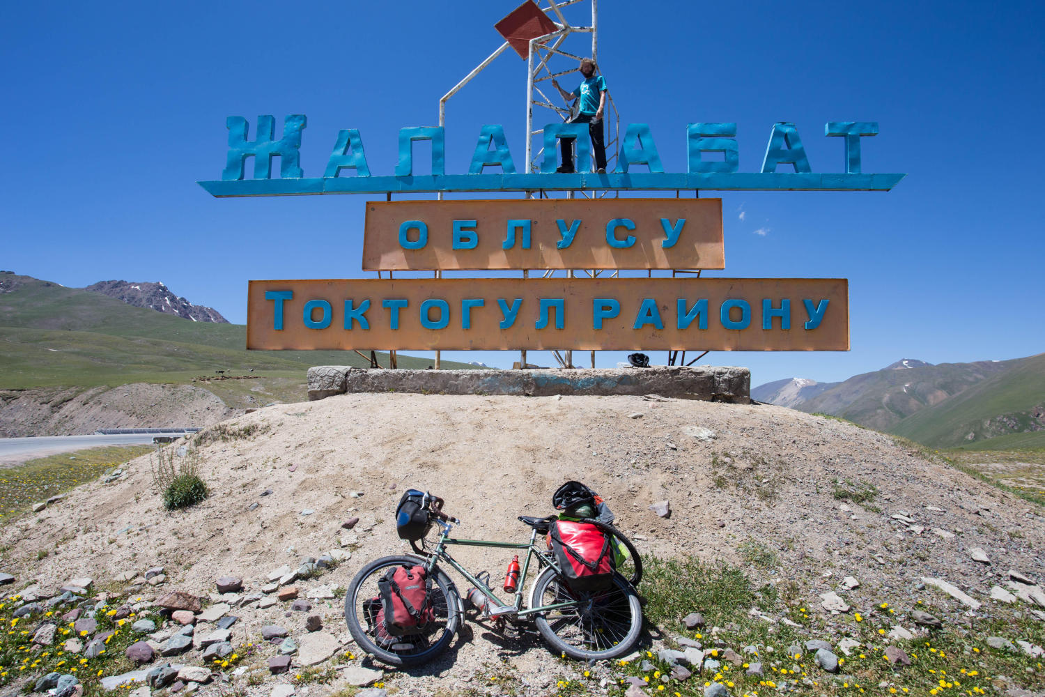 Trying to take a more unique summit photo at the top of the 3,175-metre Ala-Bel pass between Osh and Bishkek