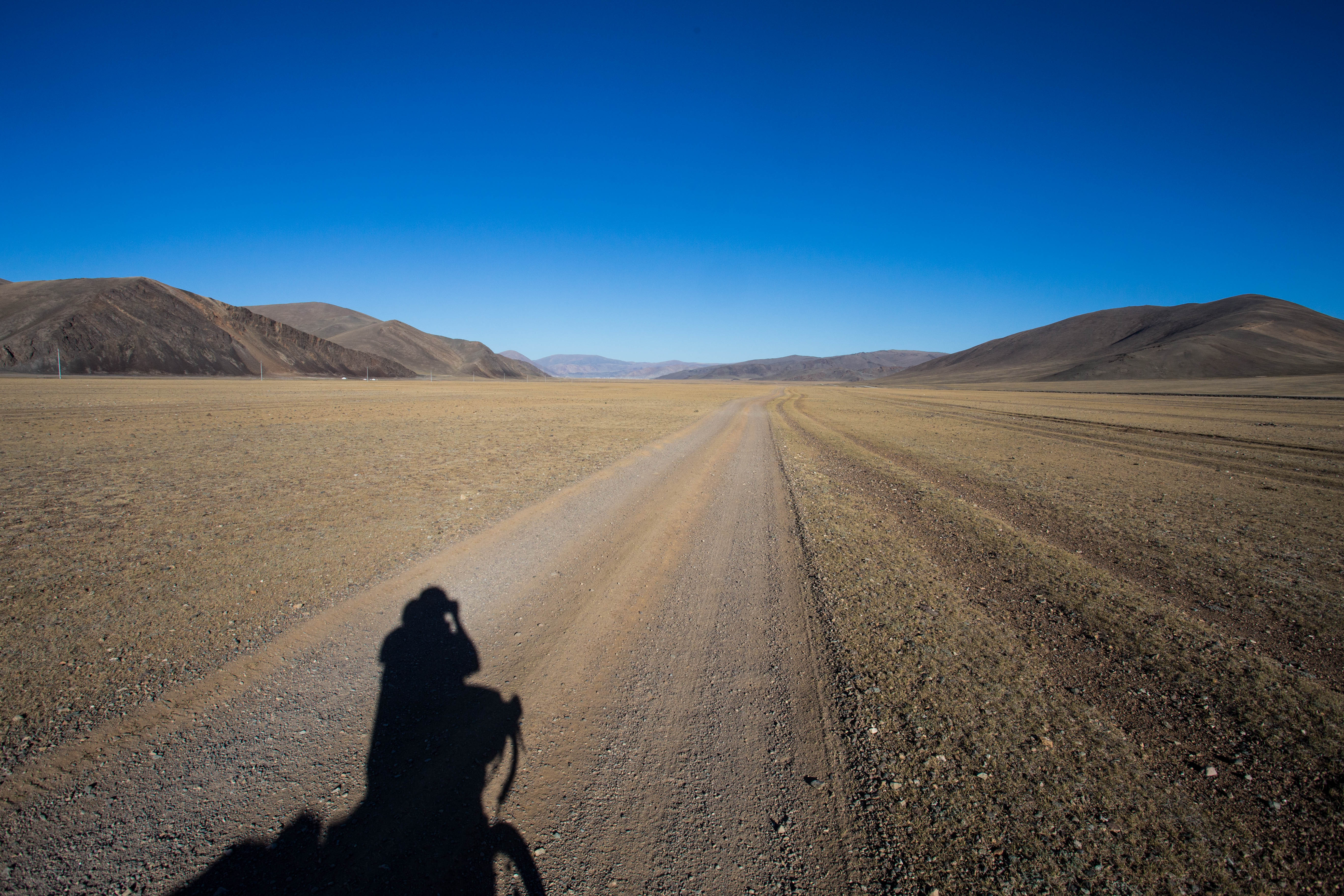 Chasing my shadow eastwards across the plains of Western Mongolia towards the village of Tsagaannuur