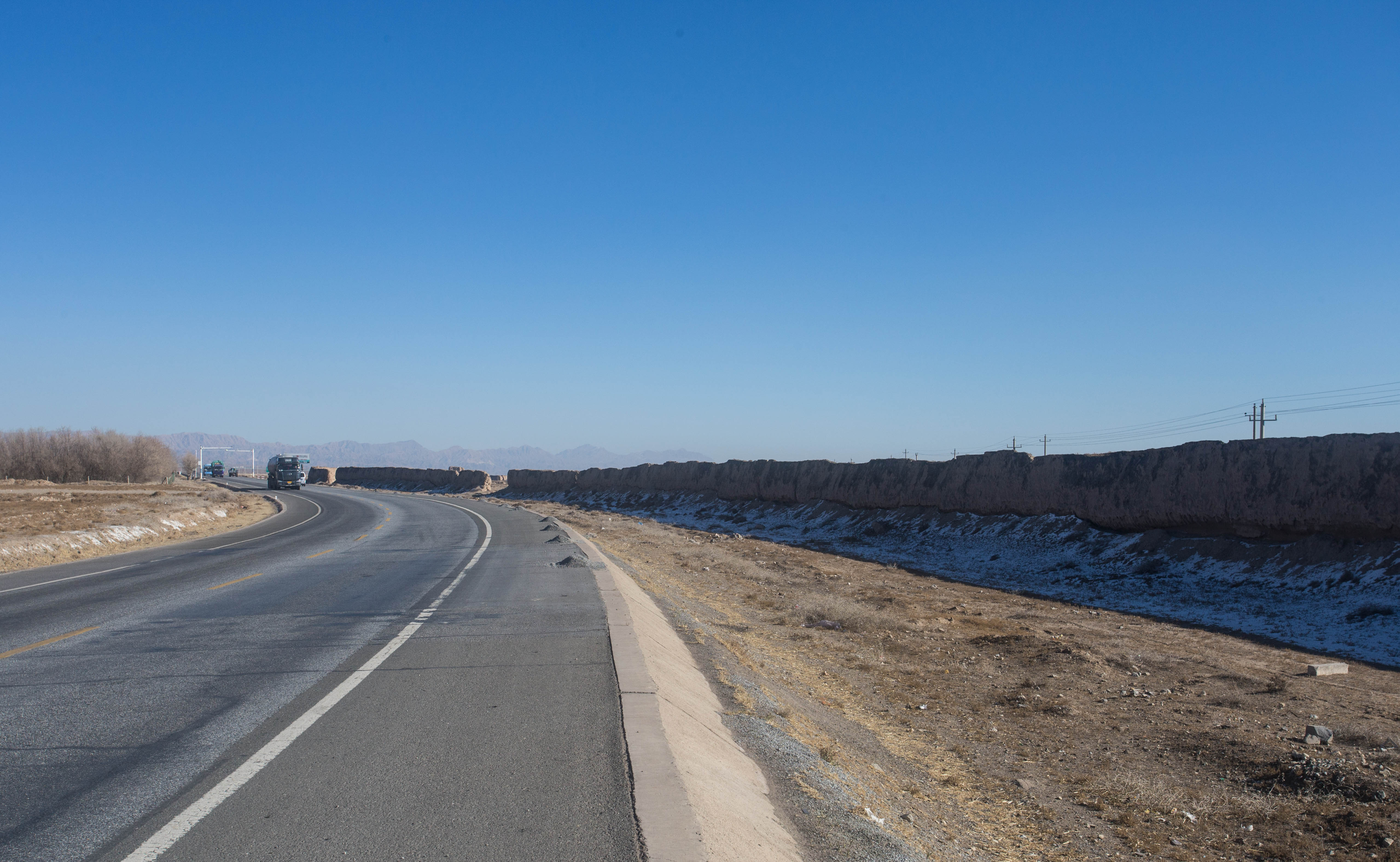 The Great Wall of China, just a meagre, sunbaked mud wall for much of its length in this region of China