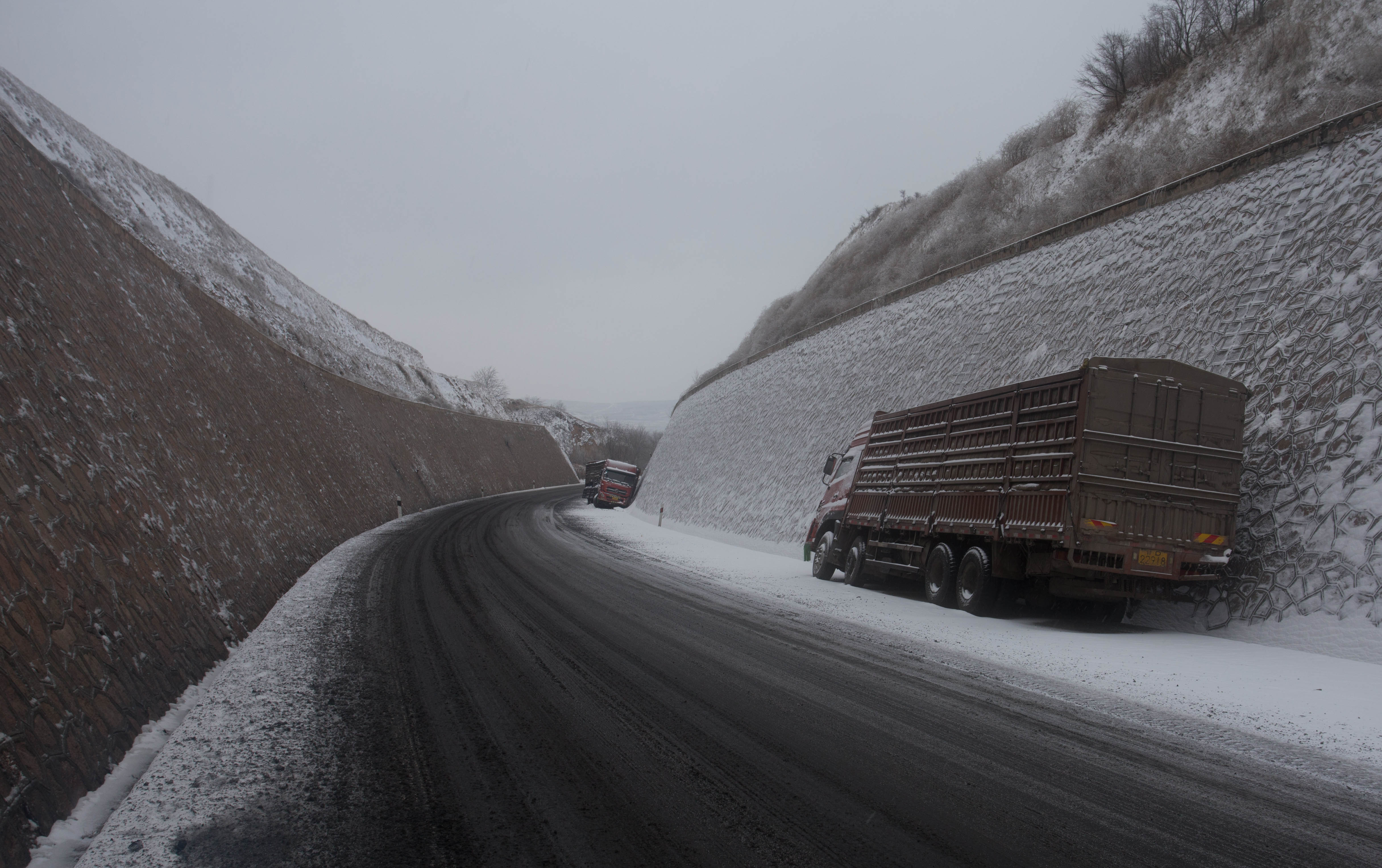 Two crashed trucks which were stranded on this bitterly cold mountainside