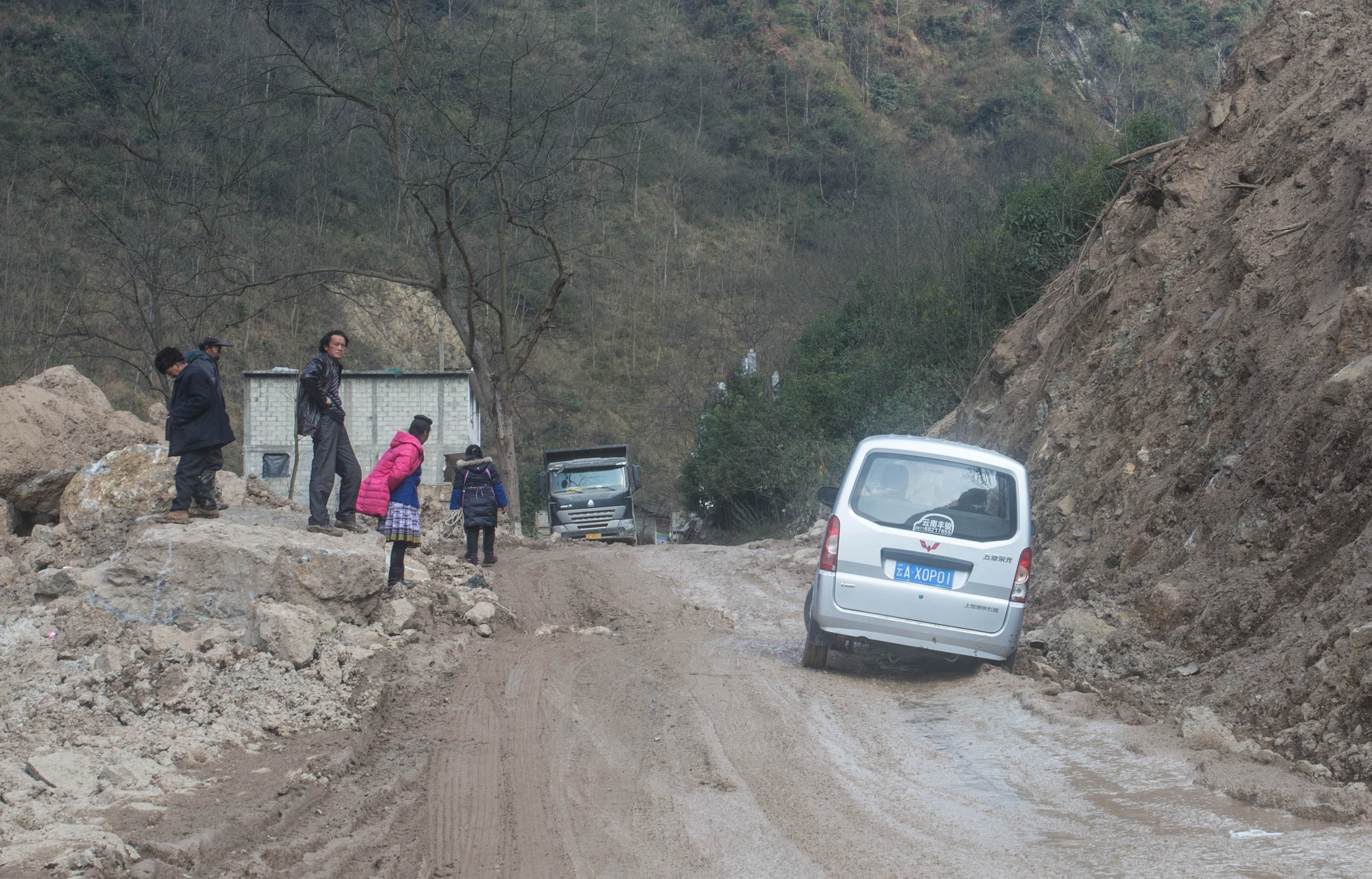 Another vehicle stuck on this main road, this time the deep mud catching out the driver
