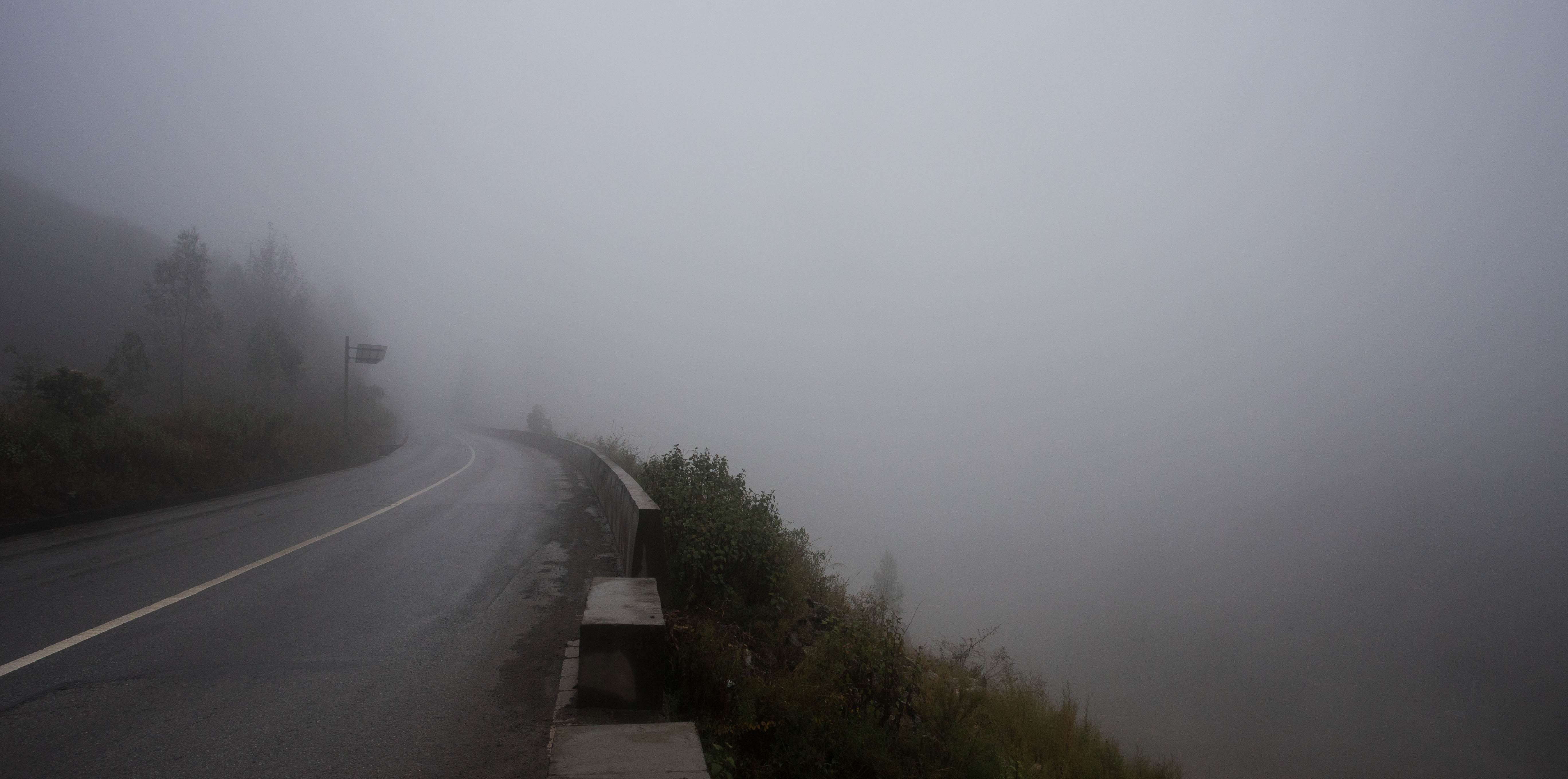 Ascending into the thick mist outside of Dongchuan with 950 kilometres of China left and only nine days to complete it