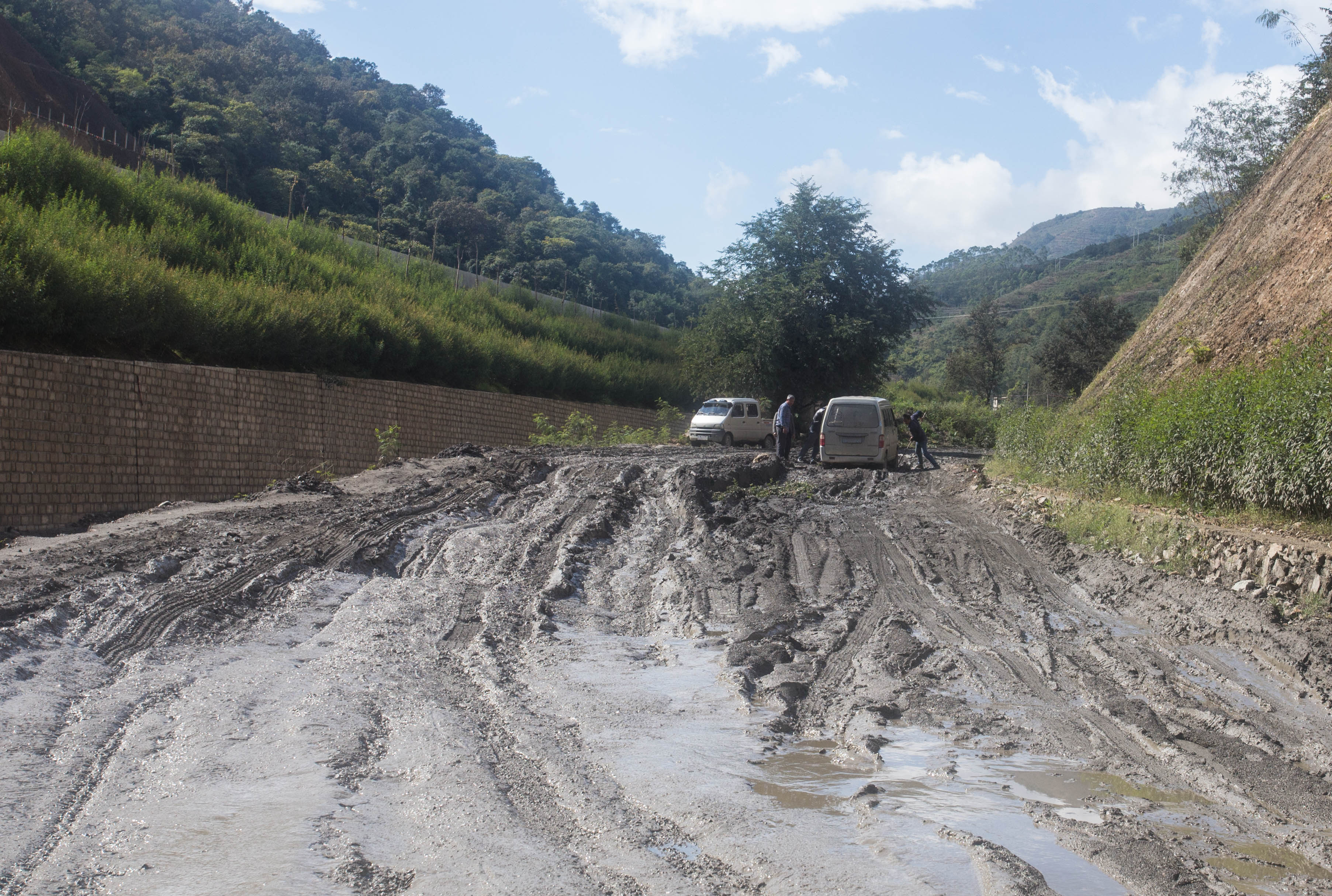 Another vehicle stuck in the deep mud of this destroyed road