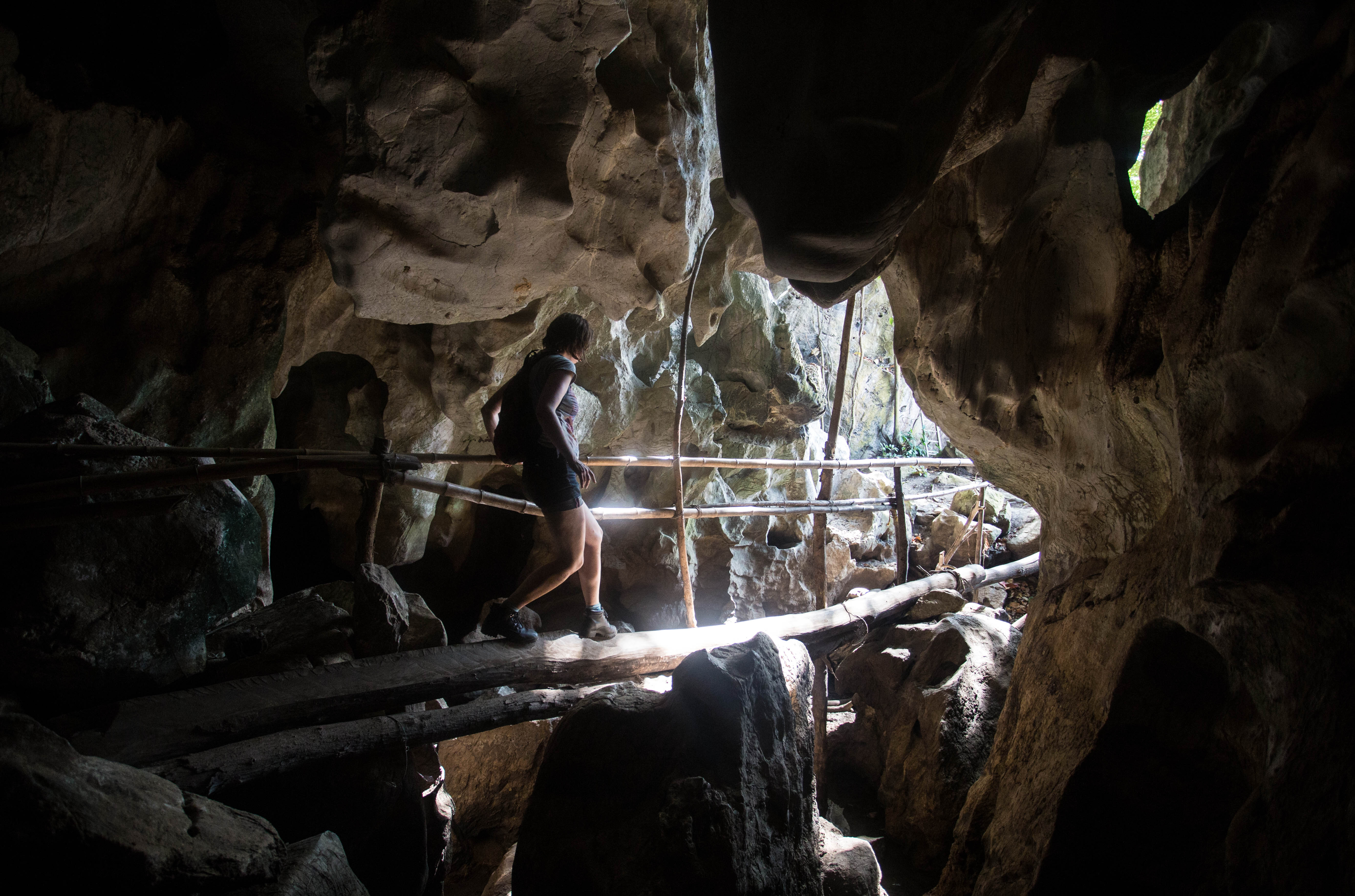 Elana tackling a sketchy, narrow bridge in one of the caves near Kampot