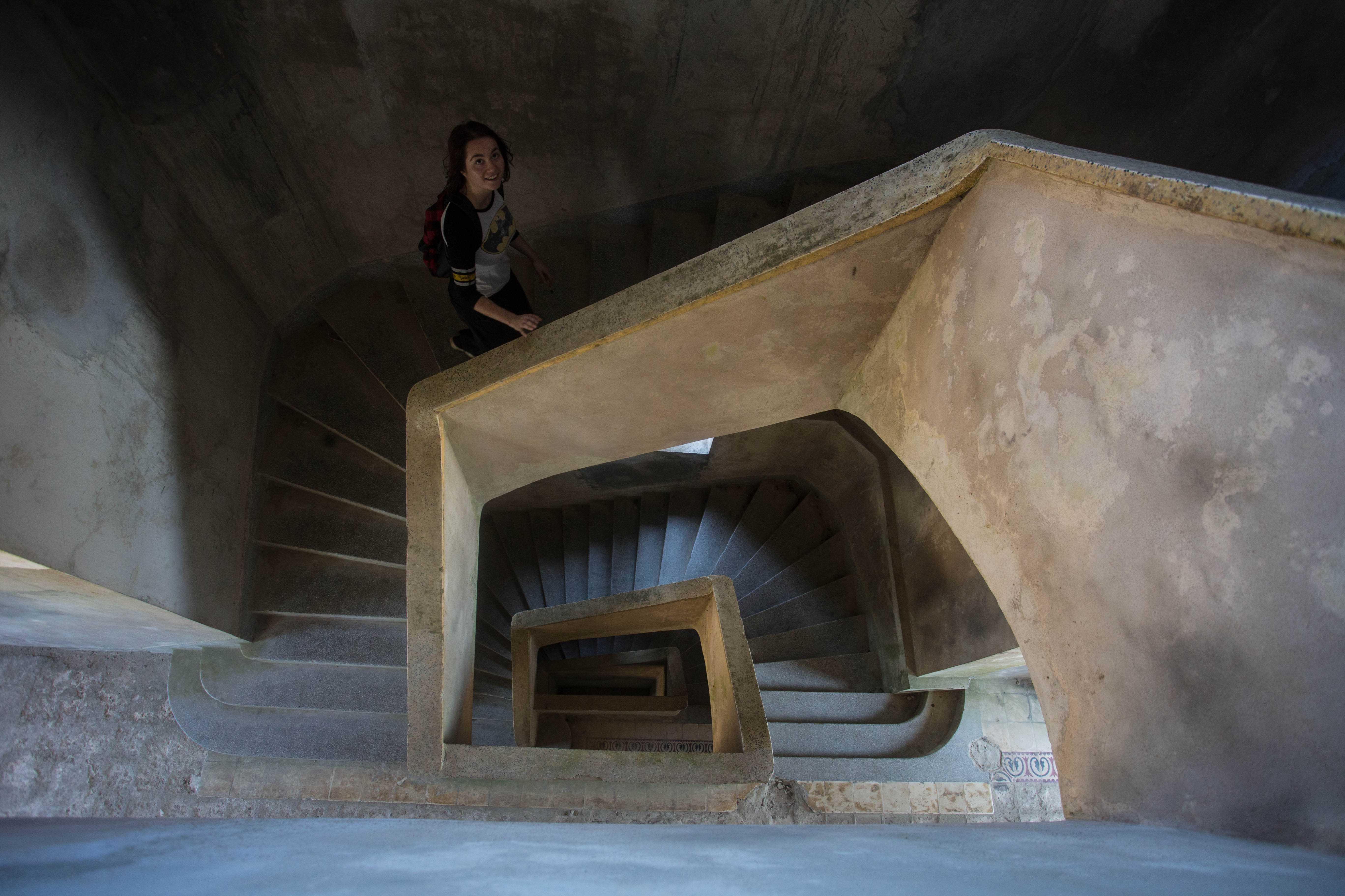 Elana climbing the stairs of a huge abandoned casino near Kampot, a relic of the French colonial era