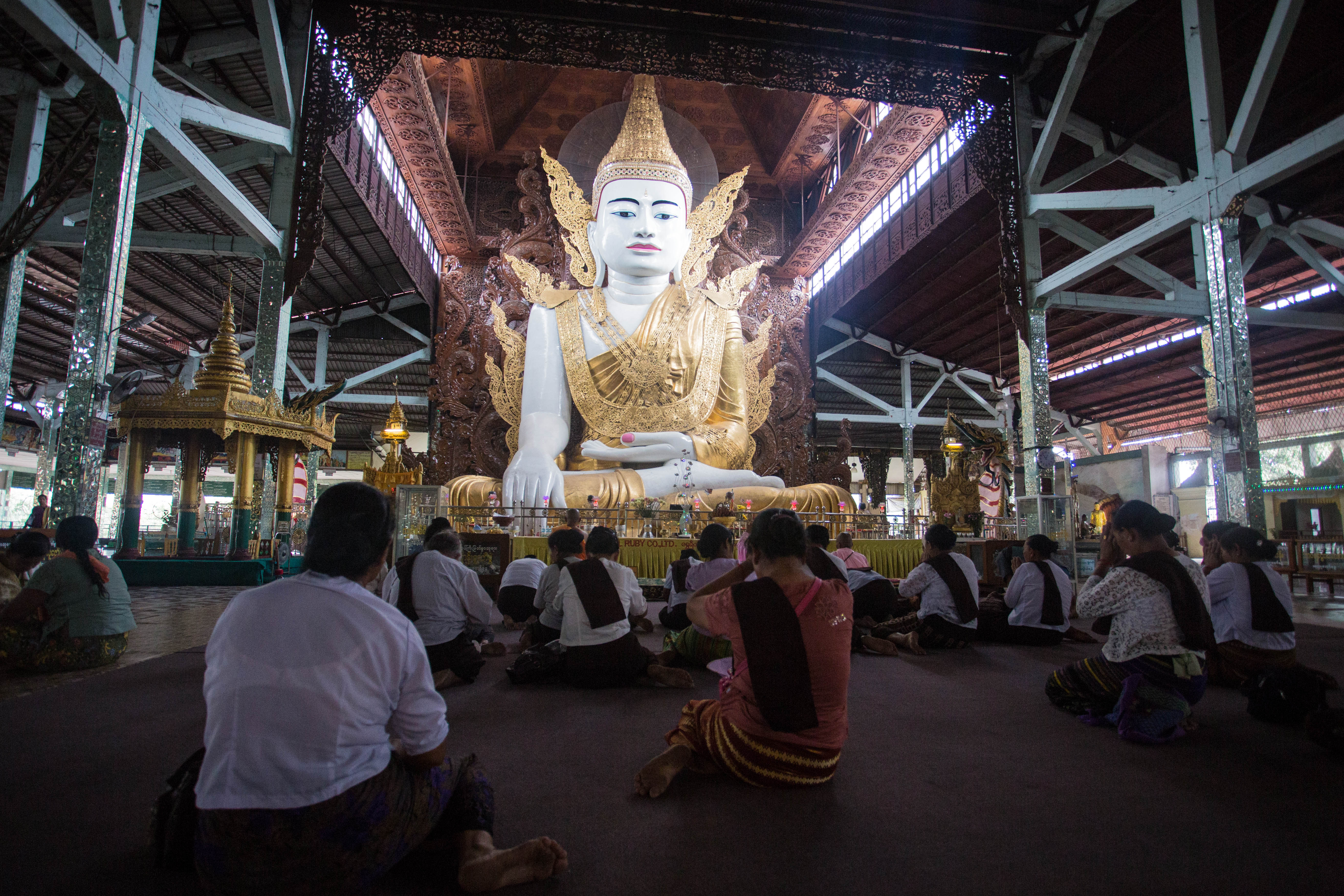 Observing Buddhist prayers at the striking Buddha in Yangon's Nga Htat Gyi Pagoda