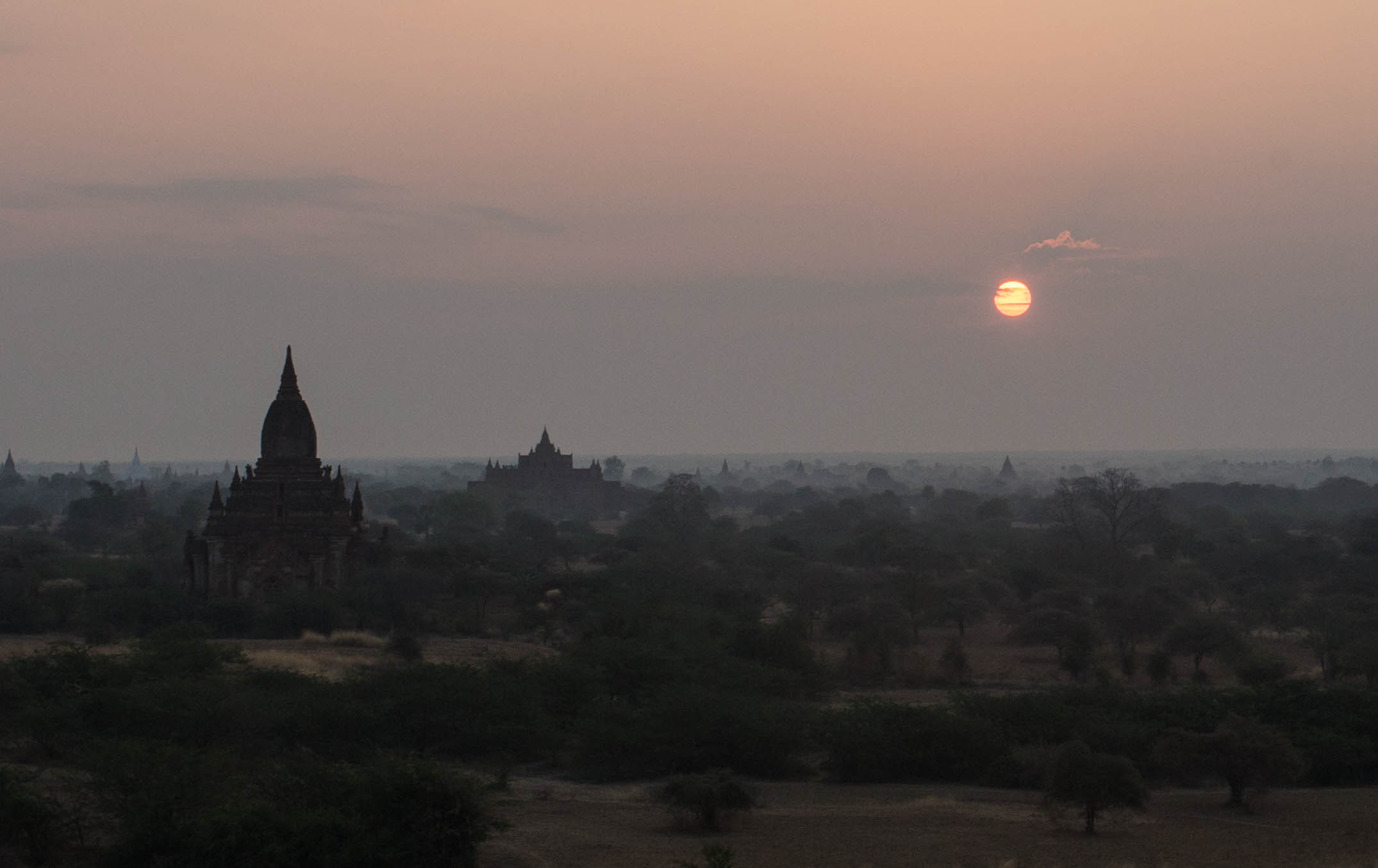 The sun rising above the low-lying mist of the plains of Bagan