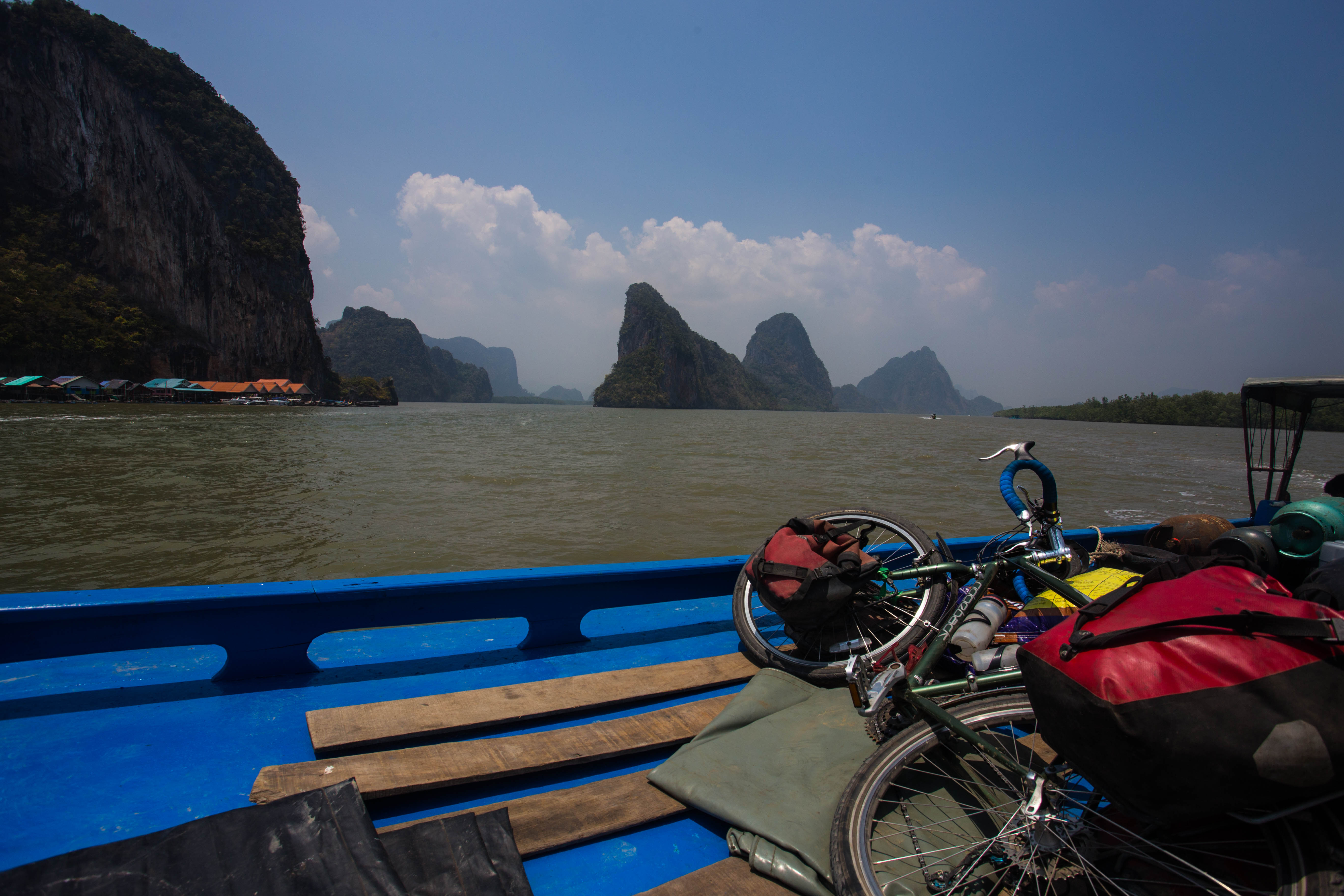 Lying back on the roof of a small boat as it heads out to the tropical island of Ko Yao Noi